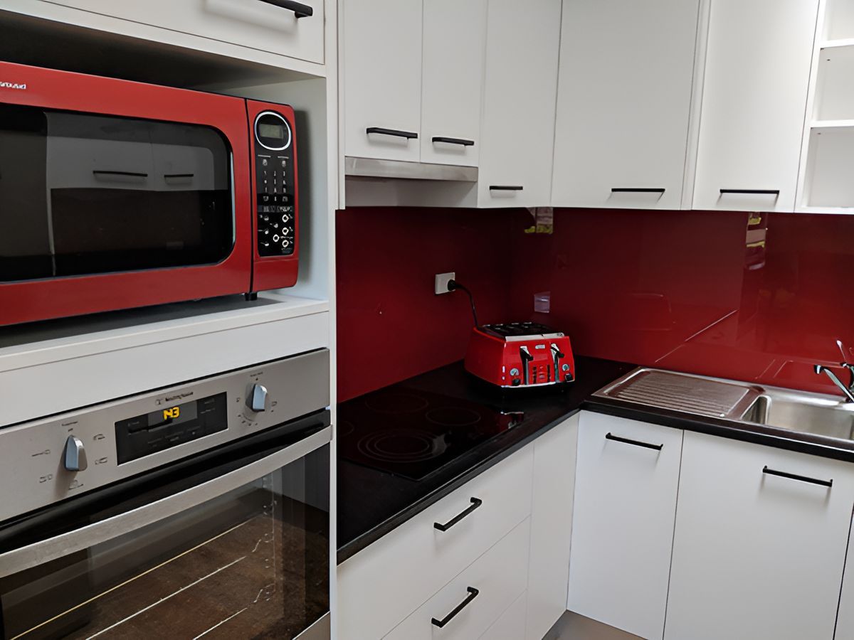 A Kitchen With a Red Microwave Oven and a Toaster Oven — Stephen Veigel Kitchens In Tuggerah, NSW