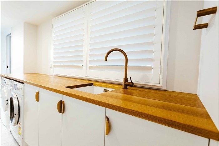 A Kitchen With a Sink , Washer and Dryer — Stephen Veigel Kitchens In Gosford, NSW
