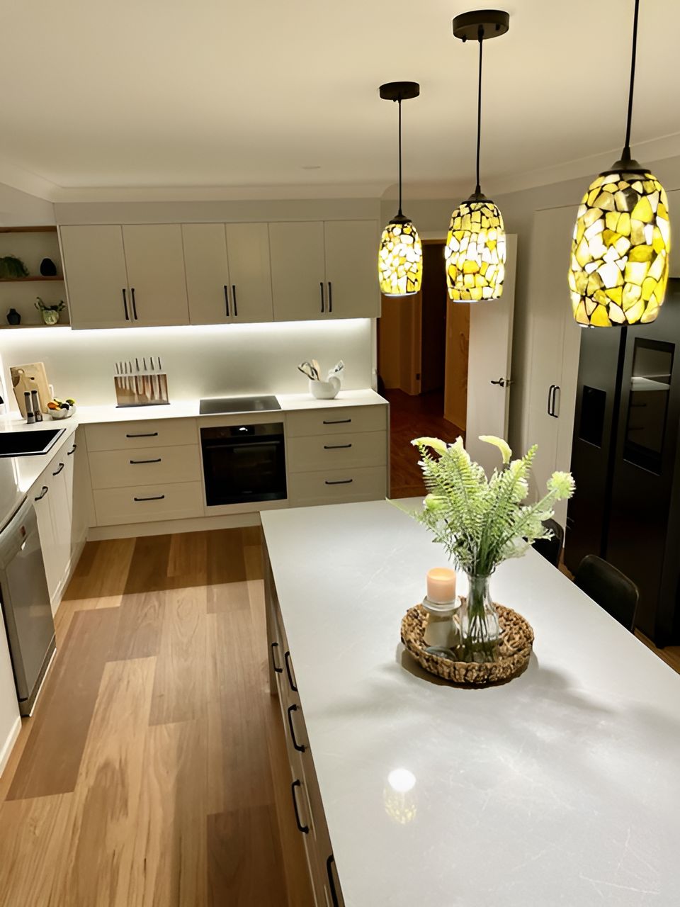 A Kitchen With a Large Island With a Vase of Flowers on It — Stephen Veigel Kitchens In Wyong, NSW