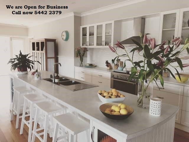Modern kitchen with white cabinets, island, and countertop.  Open for business, call 5442 2379.
