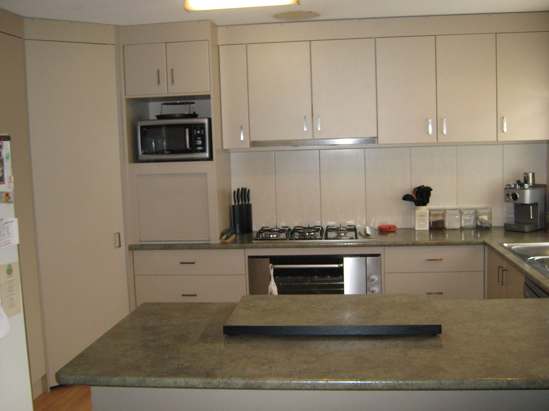 Kitchen with beige cabinets, stainless steel appliances, and granite countertops.