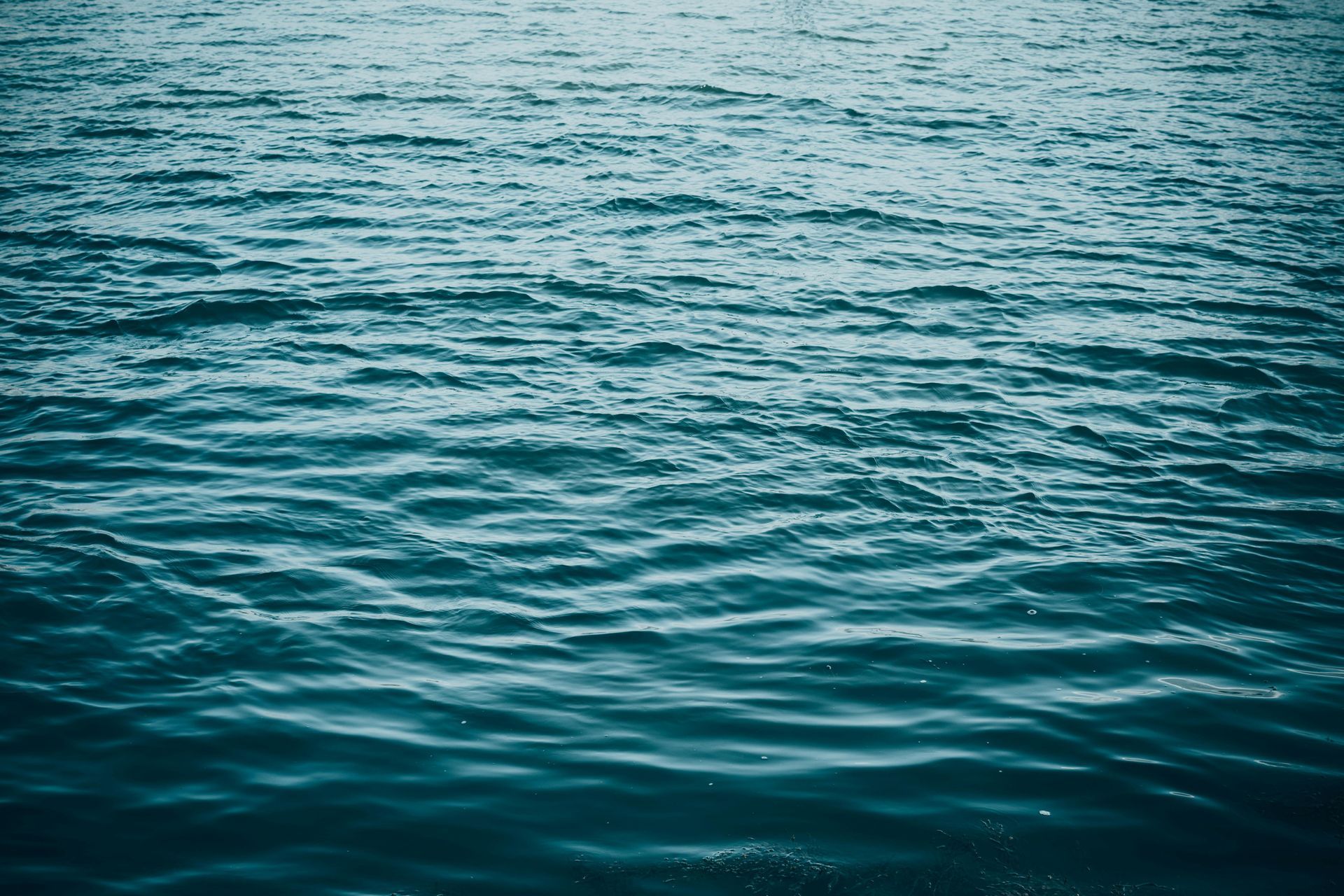 Blue ocean water with gentle ripples and reflections