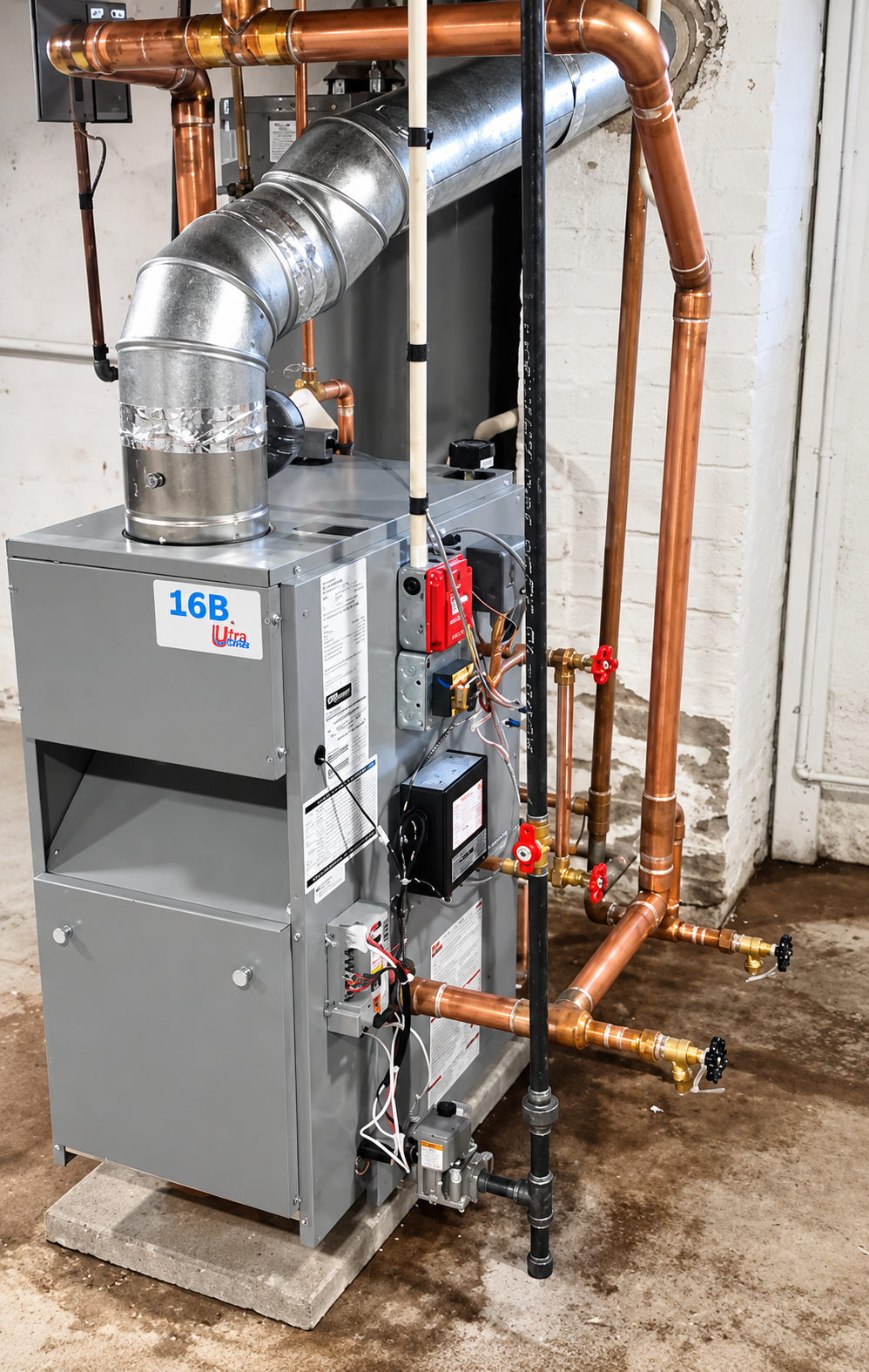 Gray HVAC furnace with copper pipes and silver ductwork in a utility room on a concrete floor