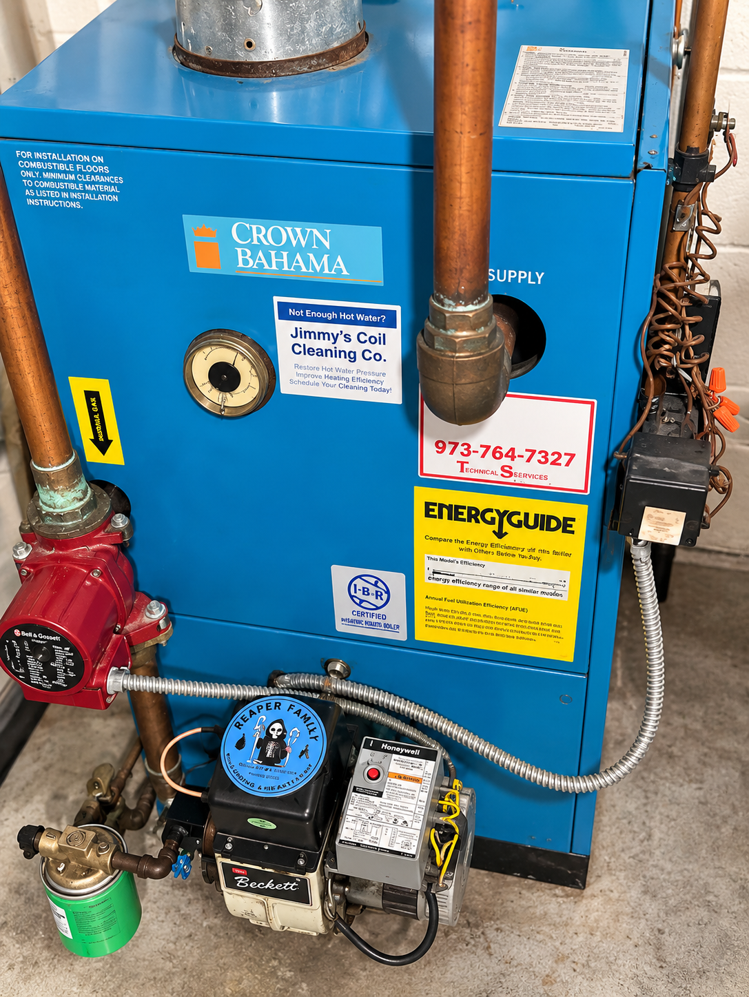 Blue Crown boiler with copper pipes, red valve, and black pump in a utility room