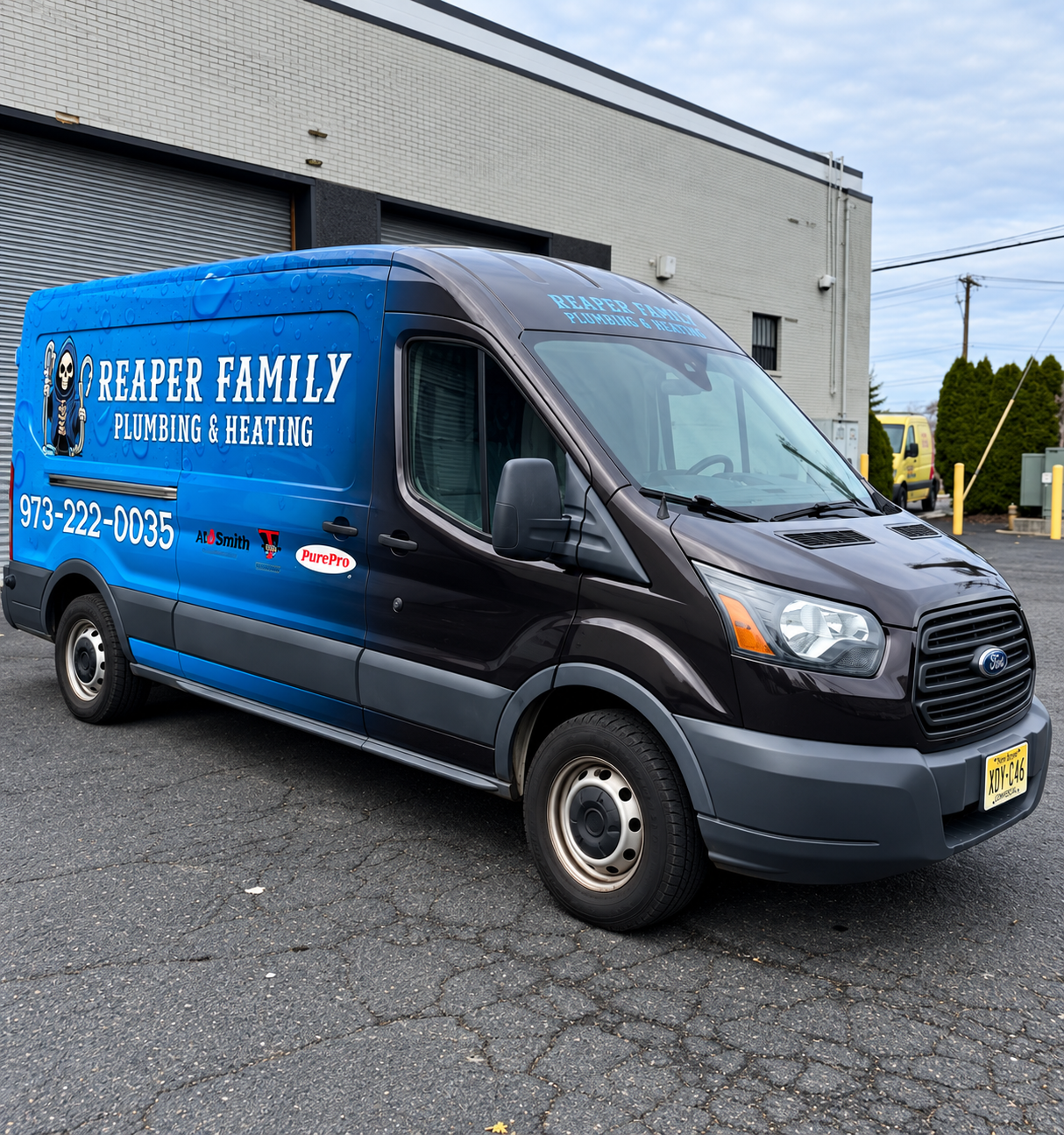 Blue “Heaper Family Heating & Cooling” service van parked outside a building.