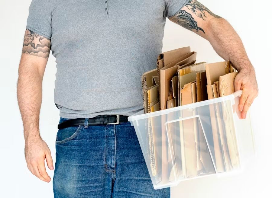 man holding a storage container with supplies in it