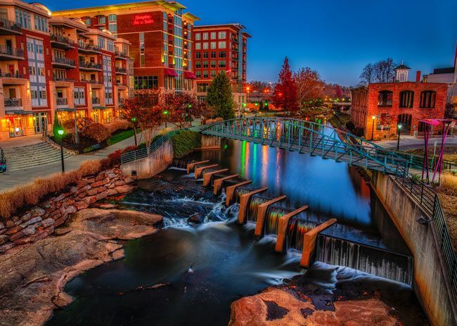 There is a bridge over a river in the middle of a city.