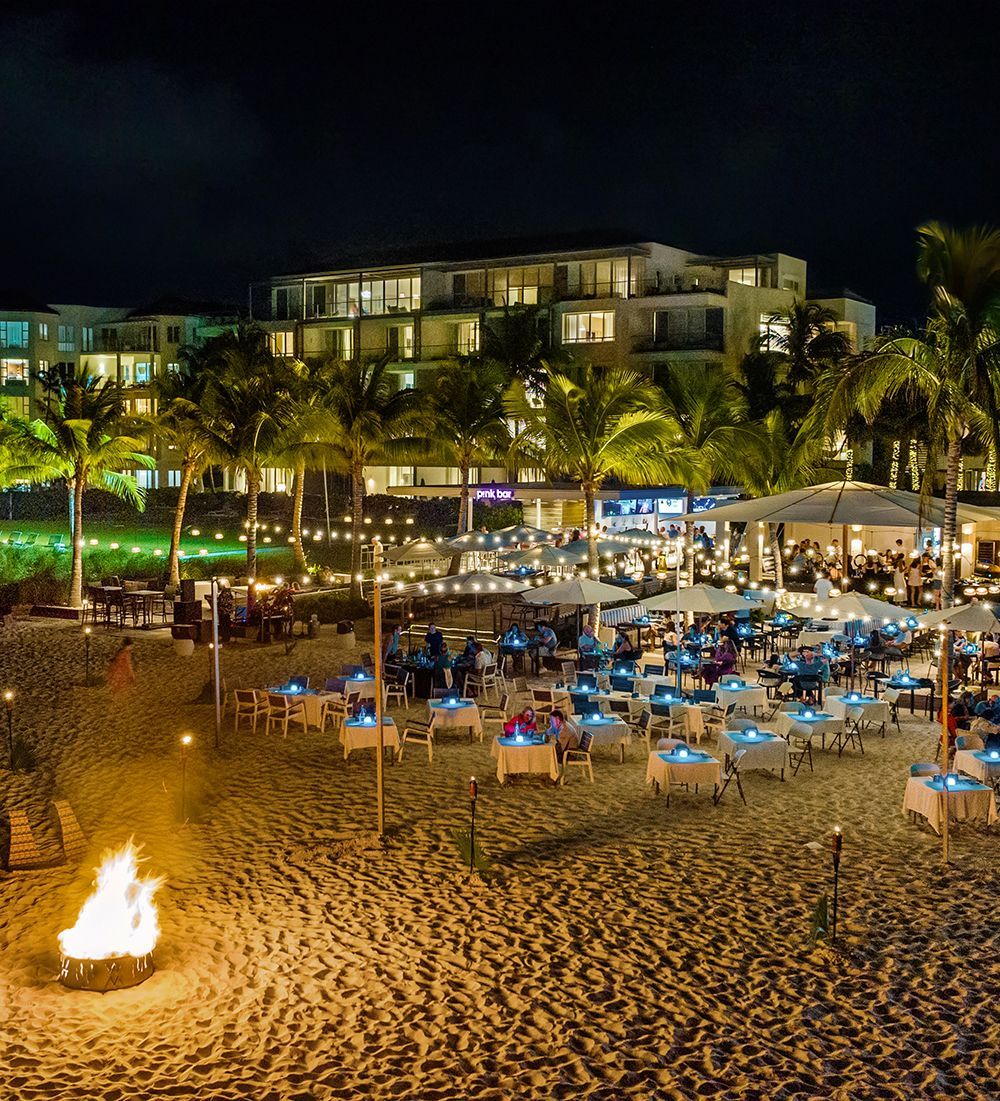 An aerial view of a beach with umbrellas and tables