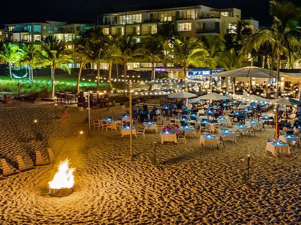 An aerial view of a beach with umbrellas and tables