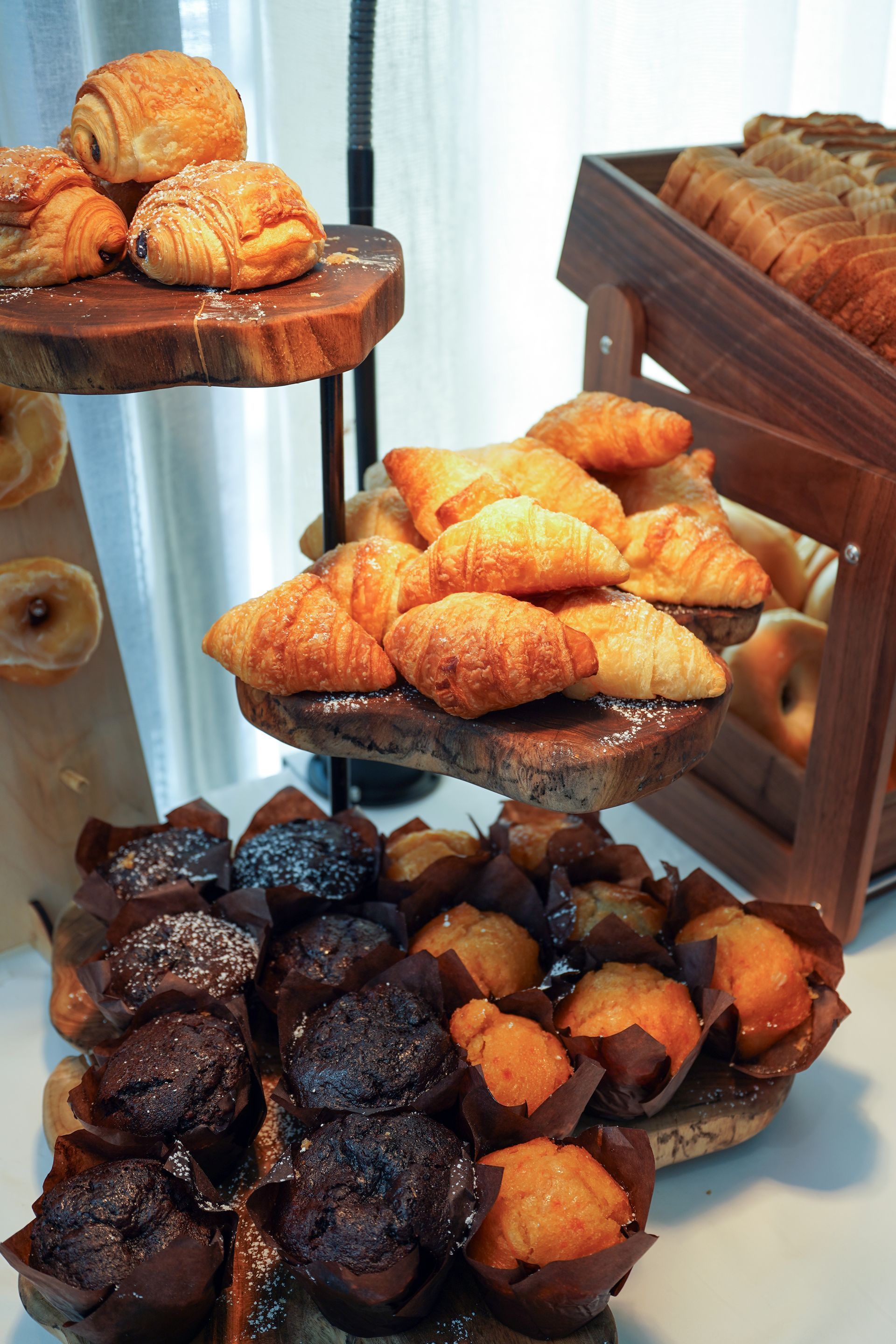 A display of pastries including croissants and muffins