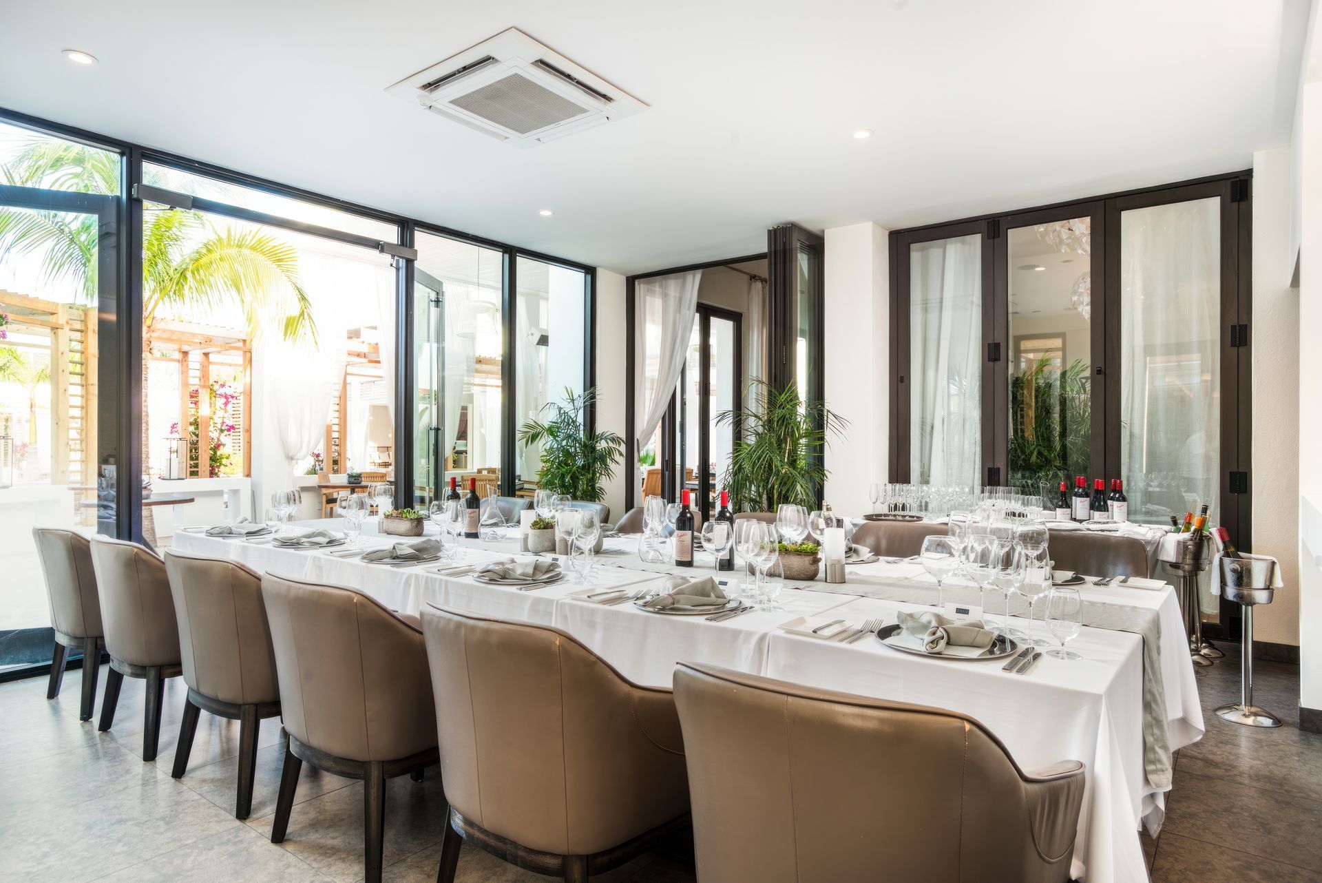 A dining room with a long table and chairs