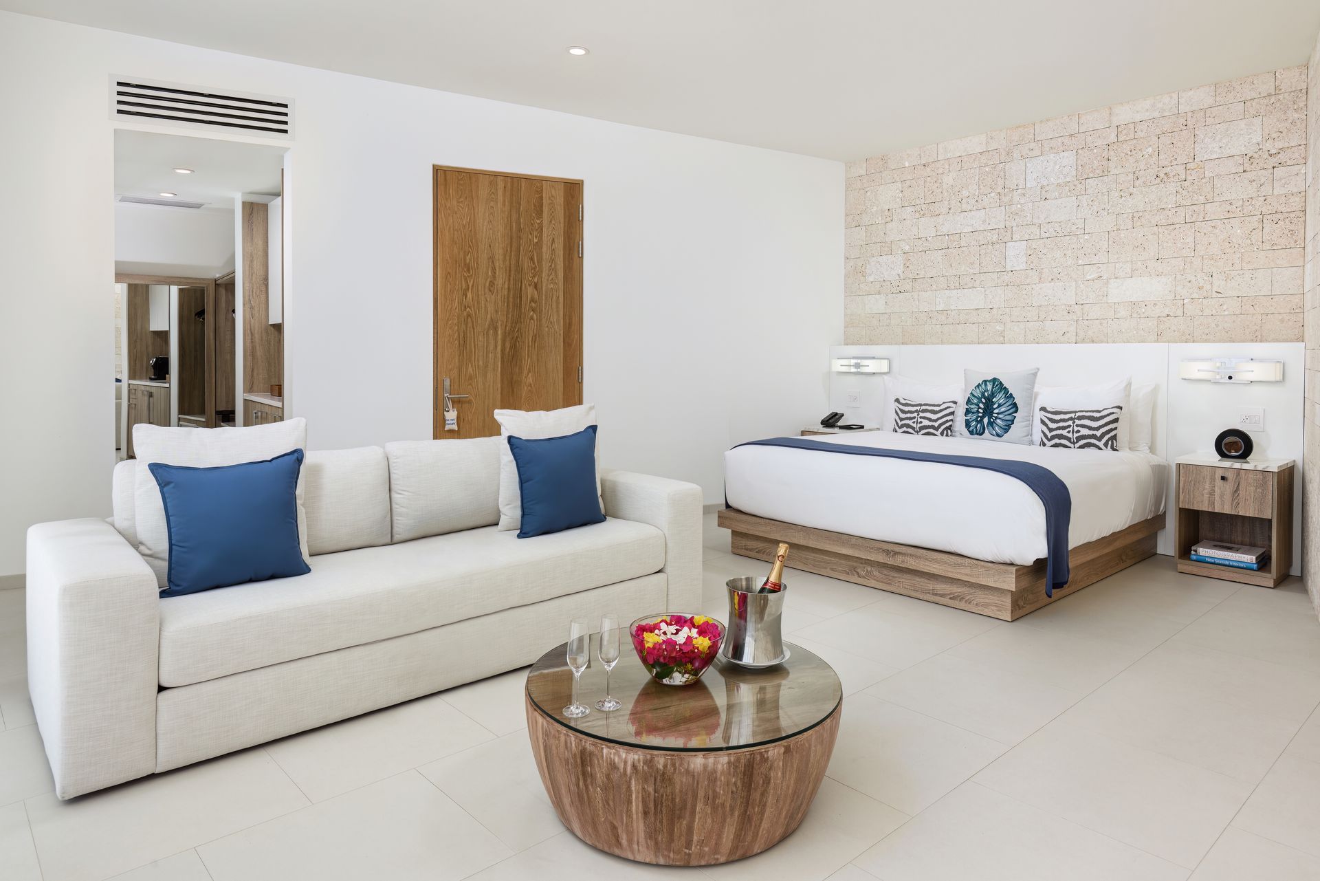 A hotel room with a king size bed and a couch