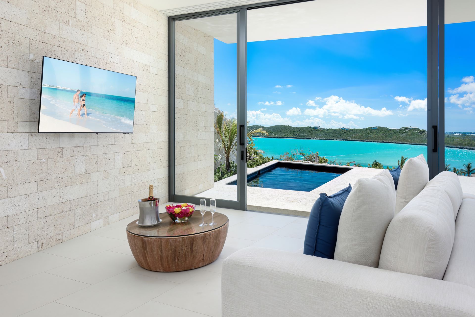 A living room with a couch a table and a flat screen tv