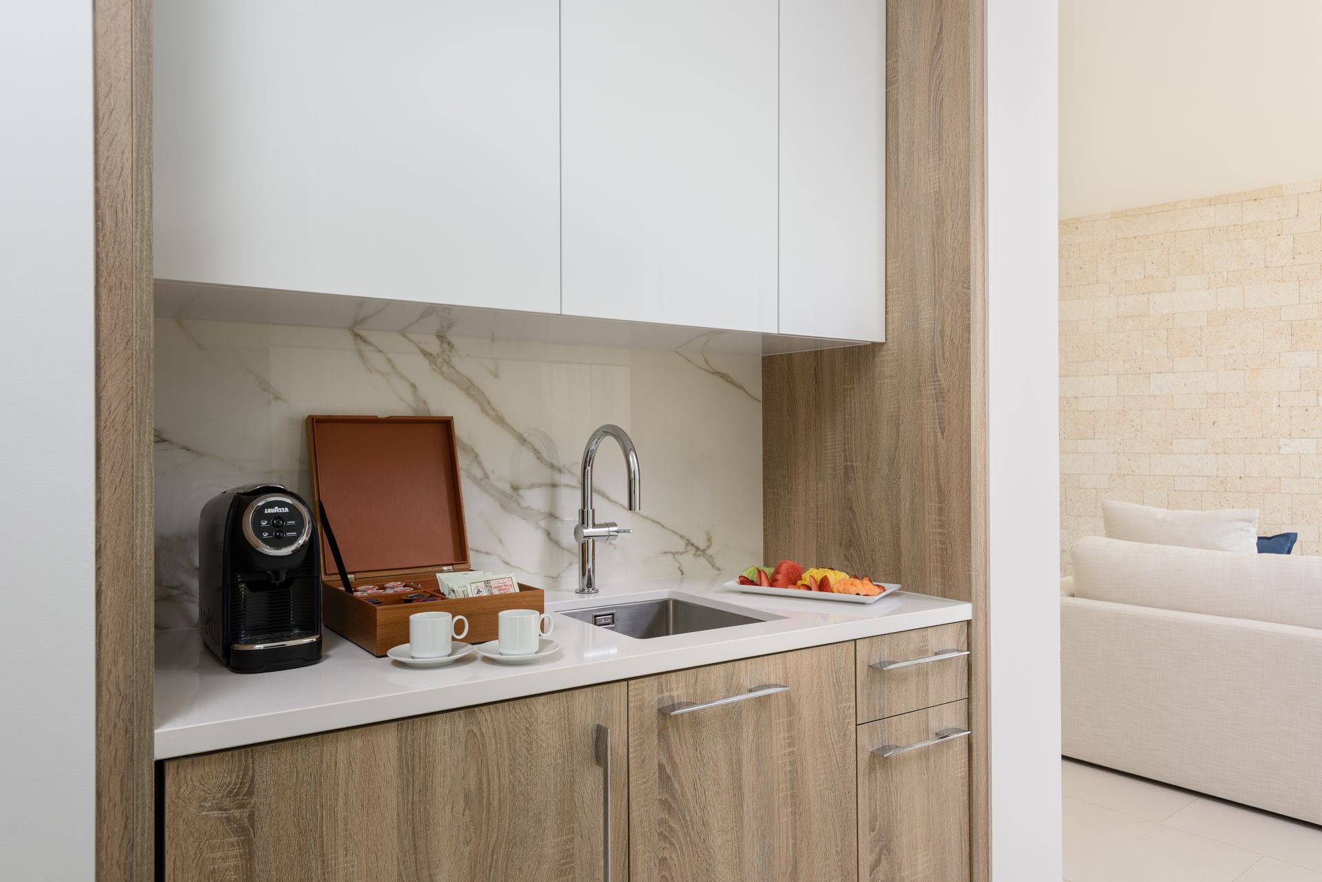 A kitchen with a sink and a coffee maker