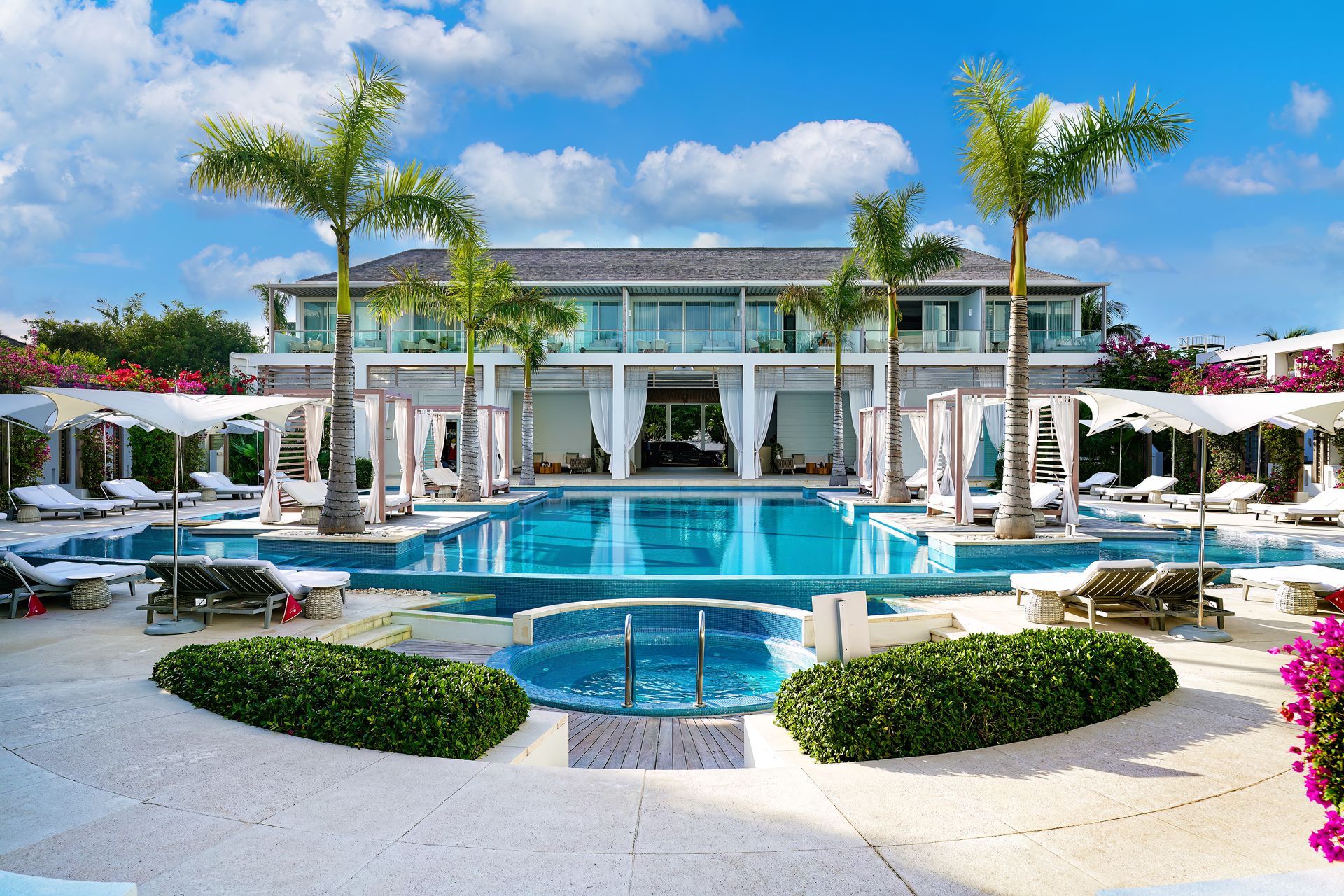 A large building with a large swimming pool in front of it