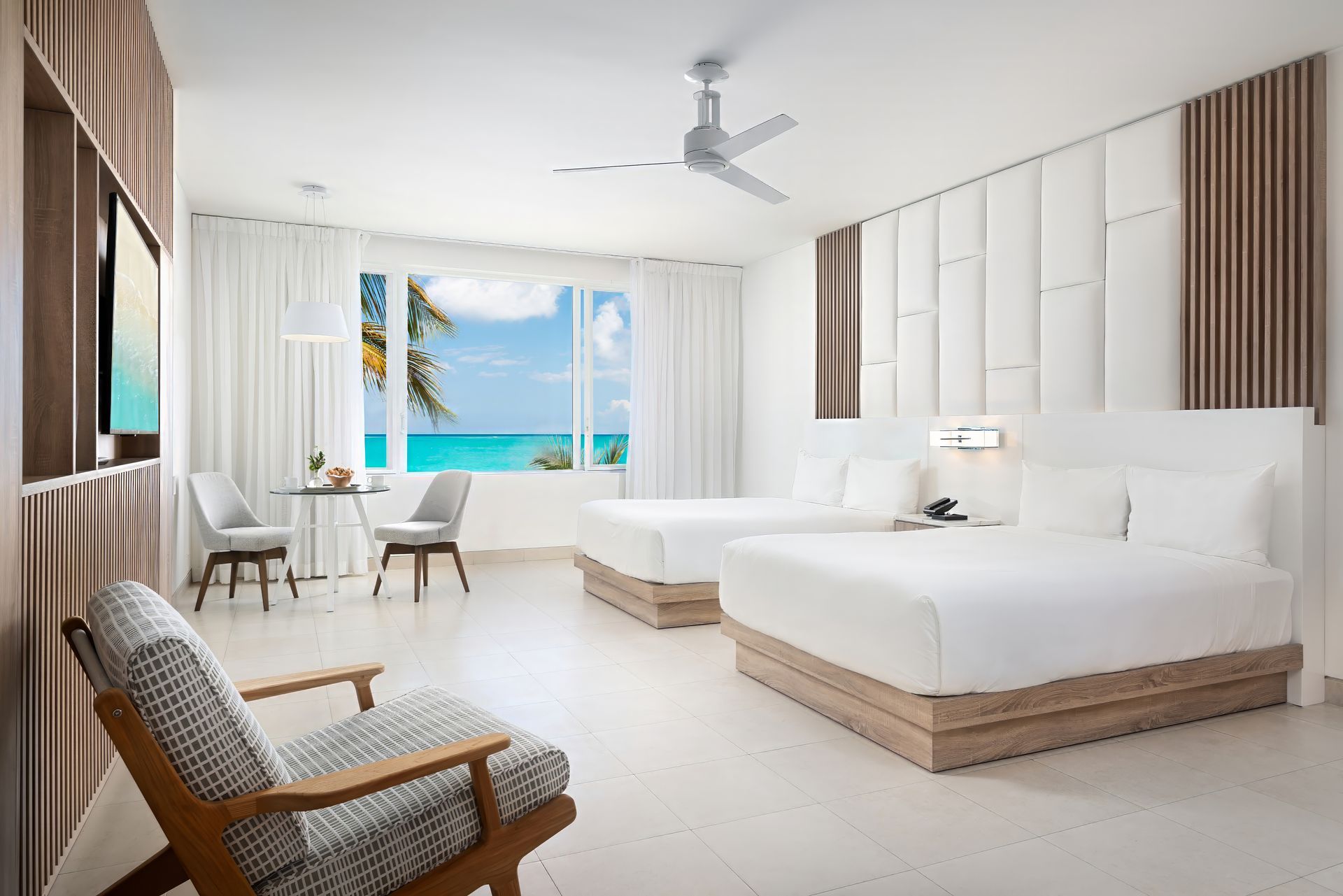 A hotel room with two beds and a chair