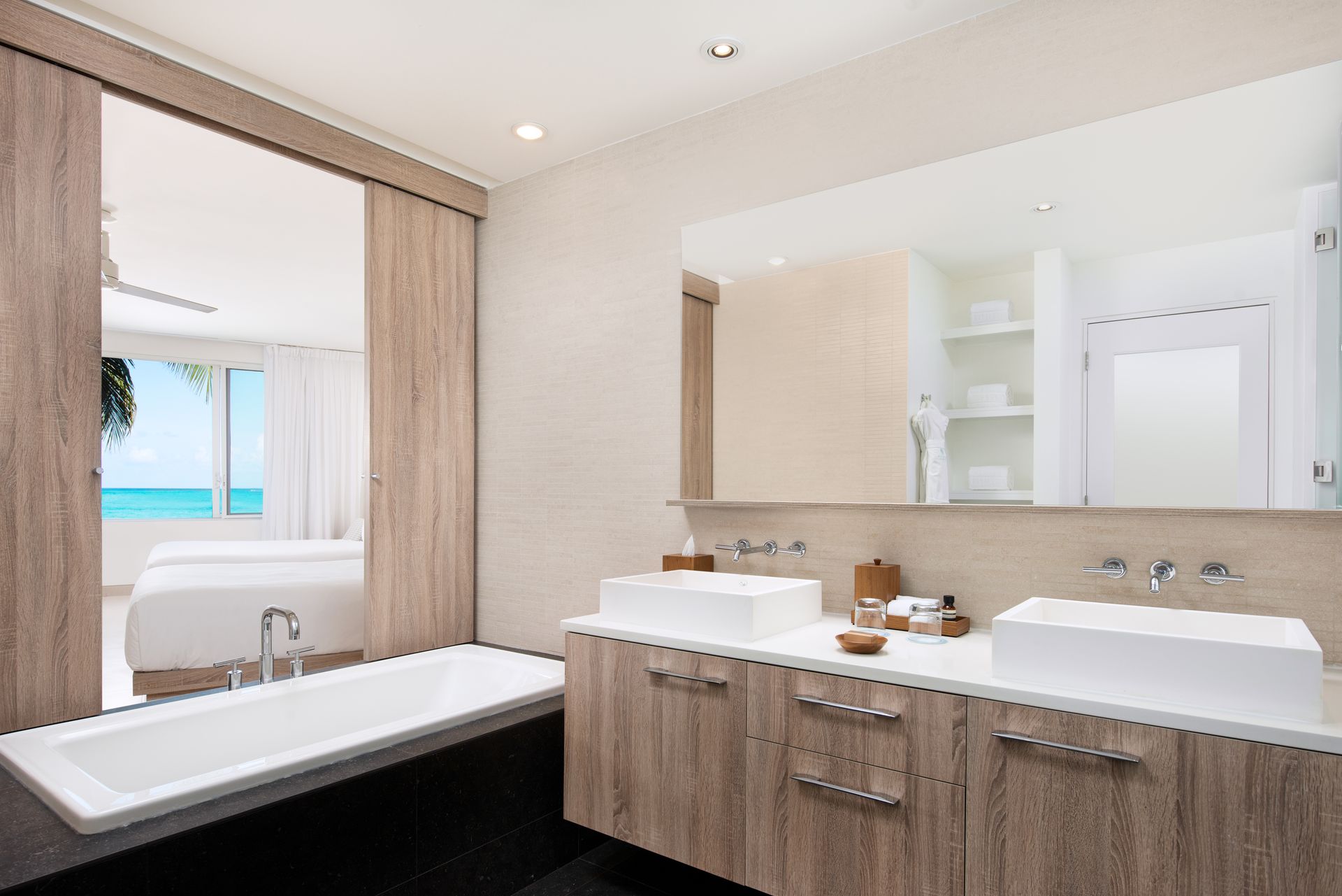 A bathroom with two sinks and a large mirror