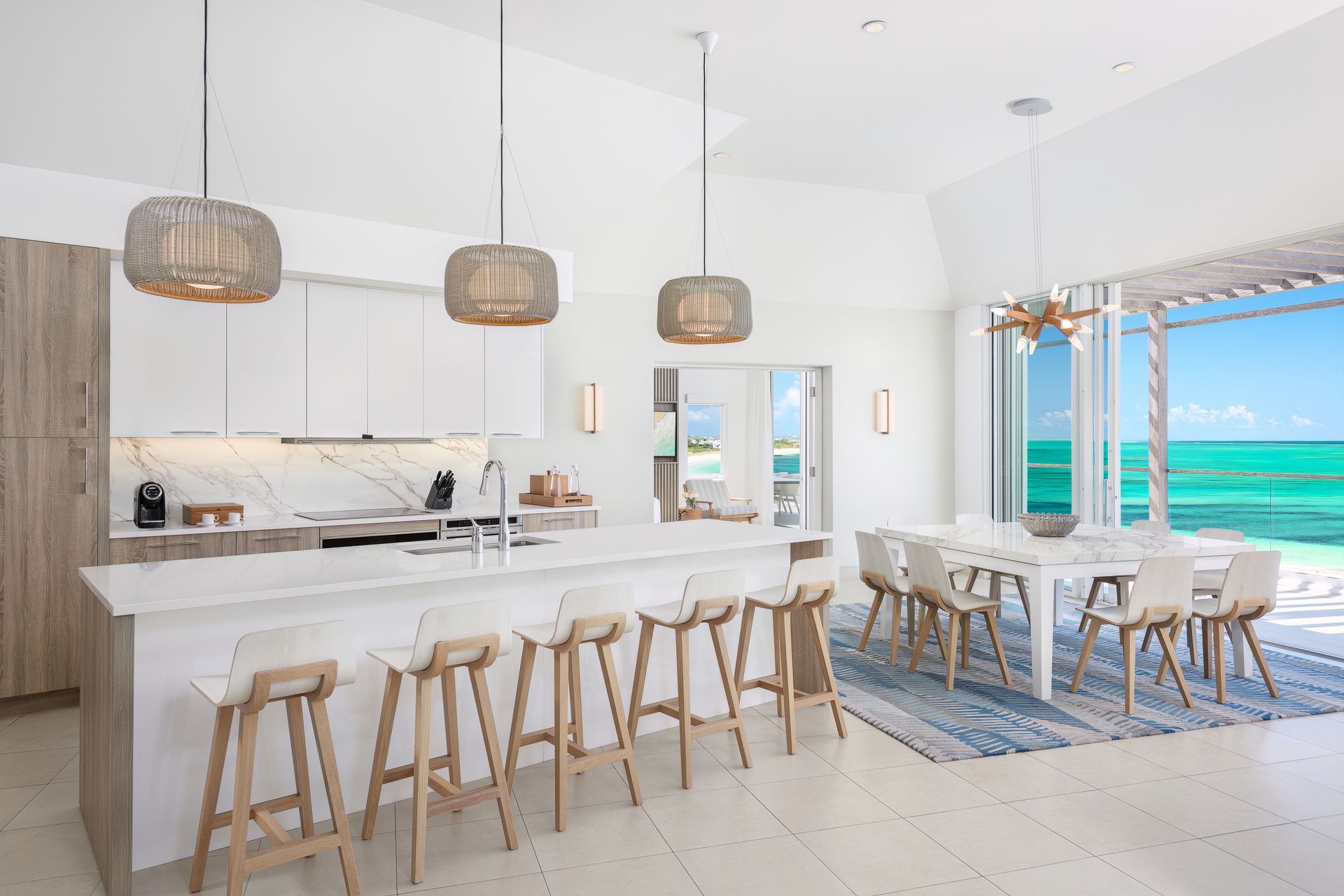 A kitchen and dining room with a view of the ocean
