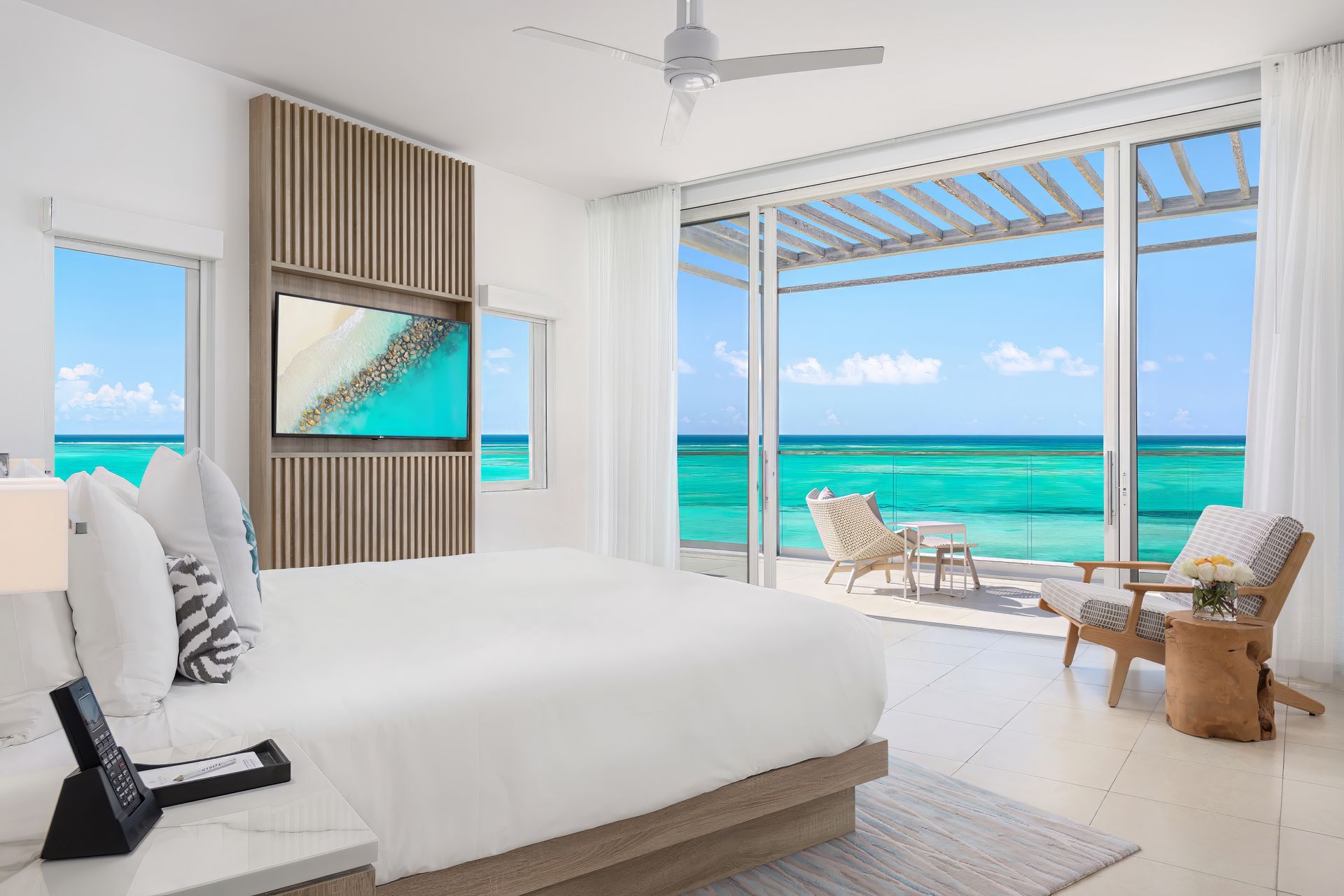 A hotel room with a large bed and a view of the ocean