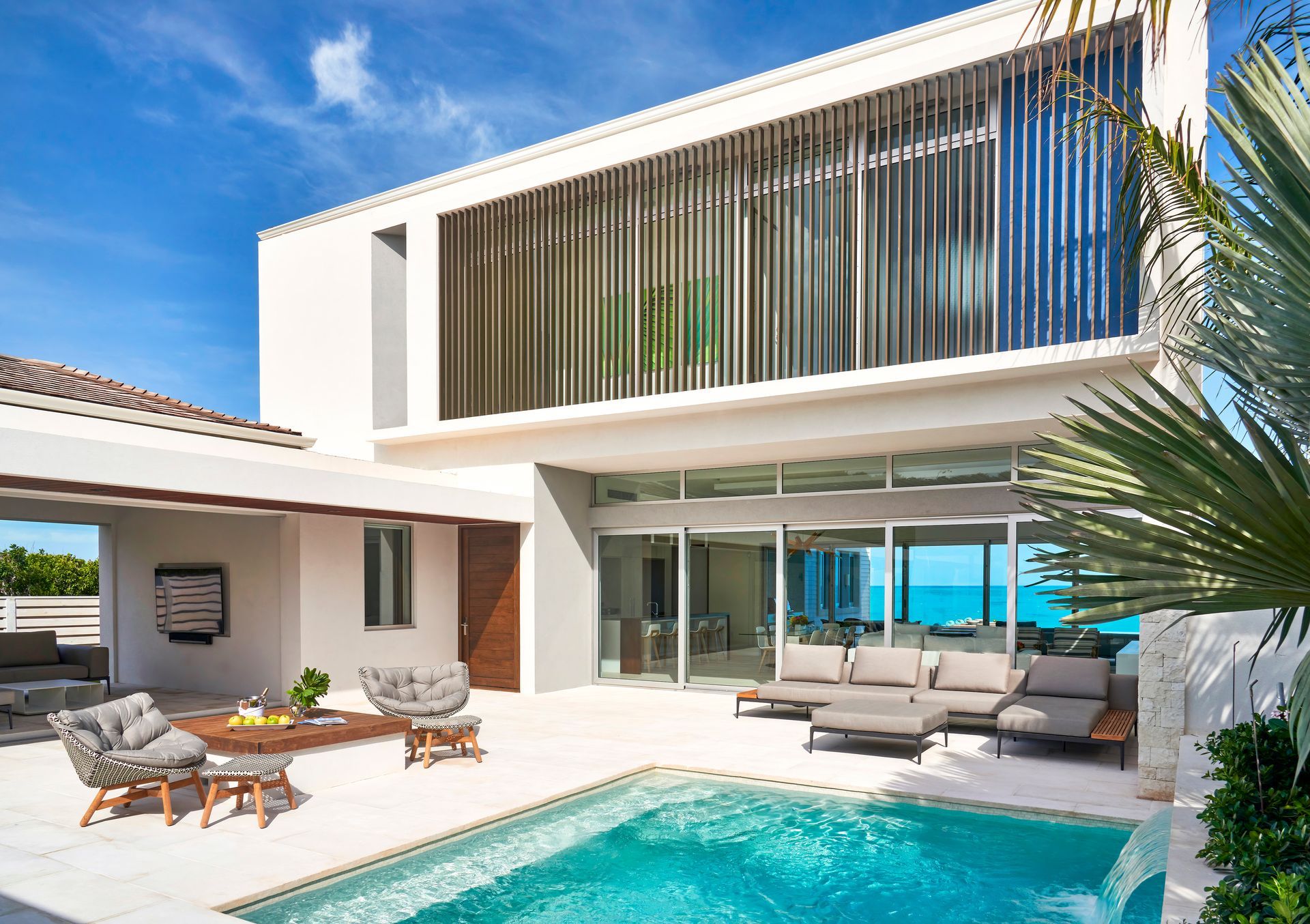A large white house with a swimming pool in front of it