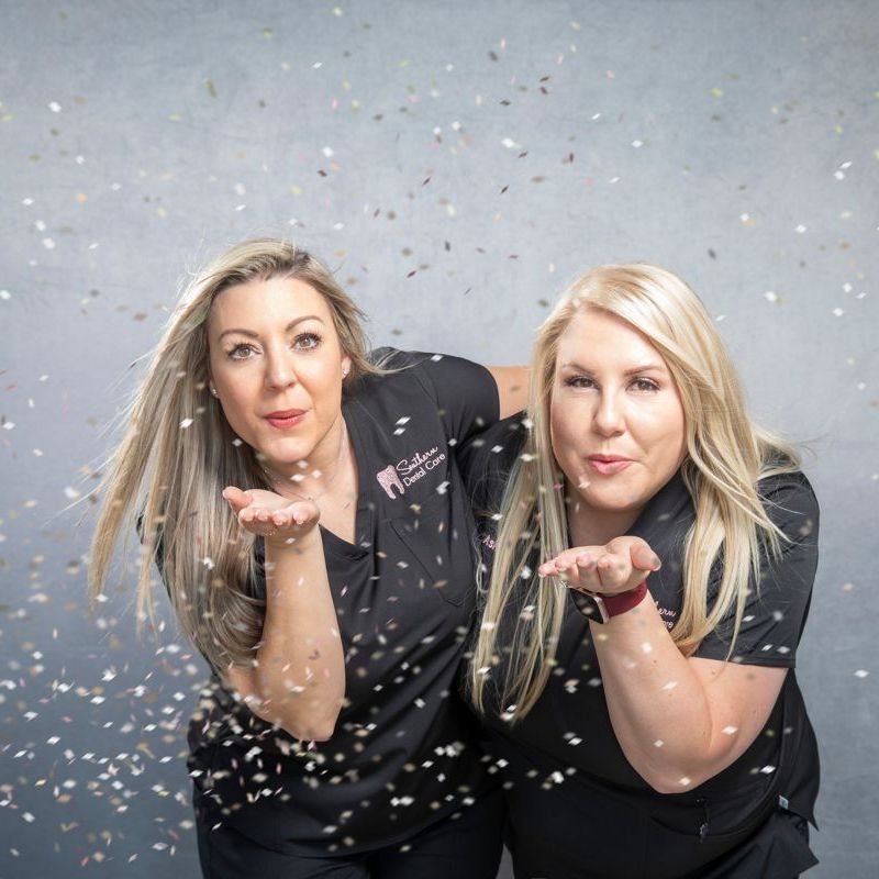 Dental staff blowing confetti | Fun family friend holist dental office near me in Marrero LA