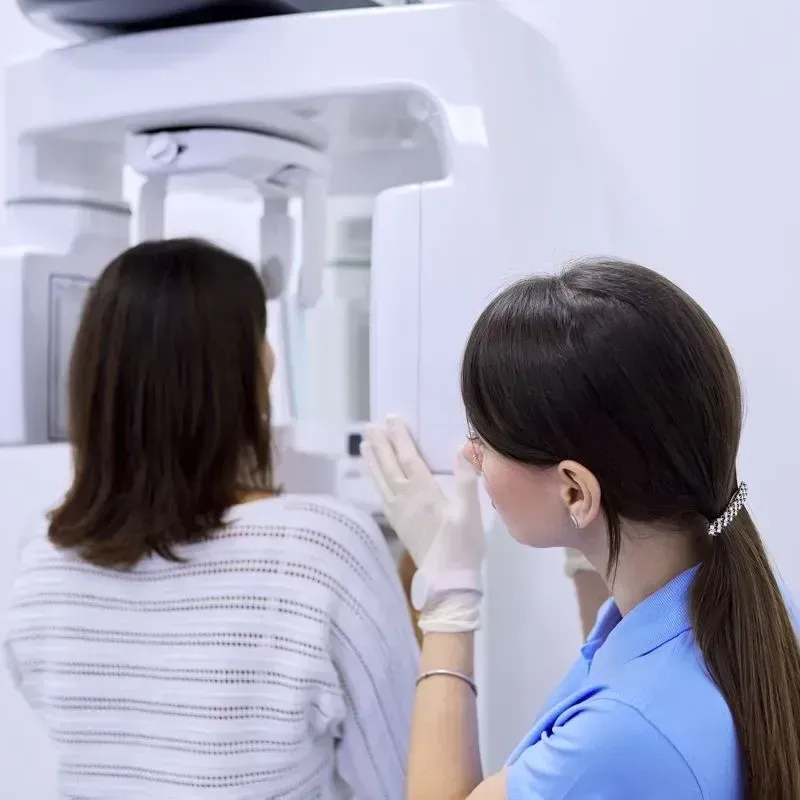 Improve your overall health with a CBCT scan at our dental office in Marrero LA. Woman getting a CBCT scan to promote optimum oral health | Dentist office near Marrero LA