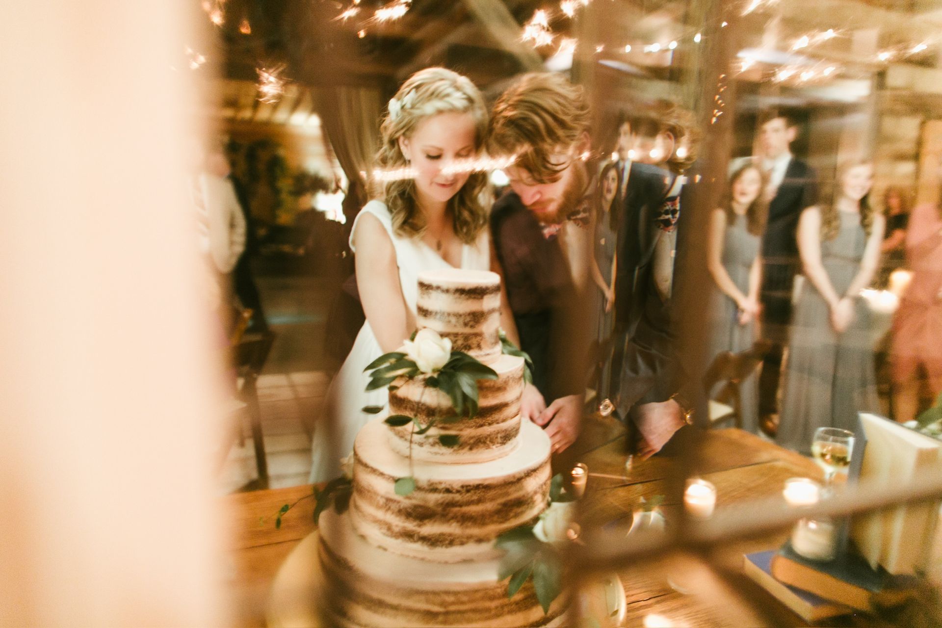 A bride and groom are cutting their wedding cake.