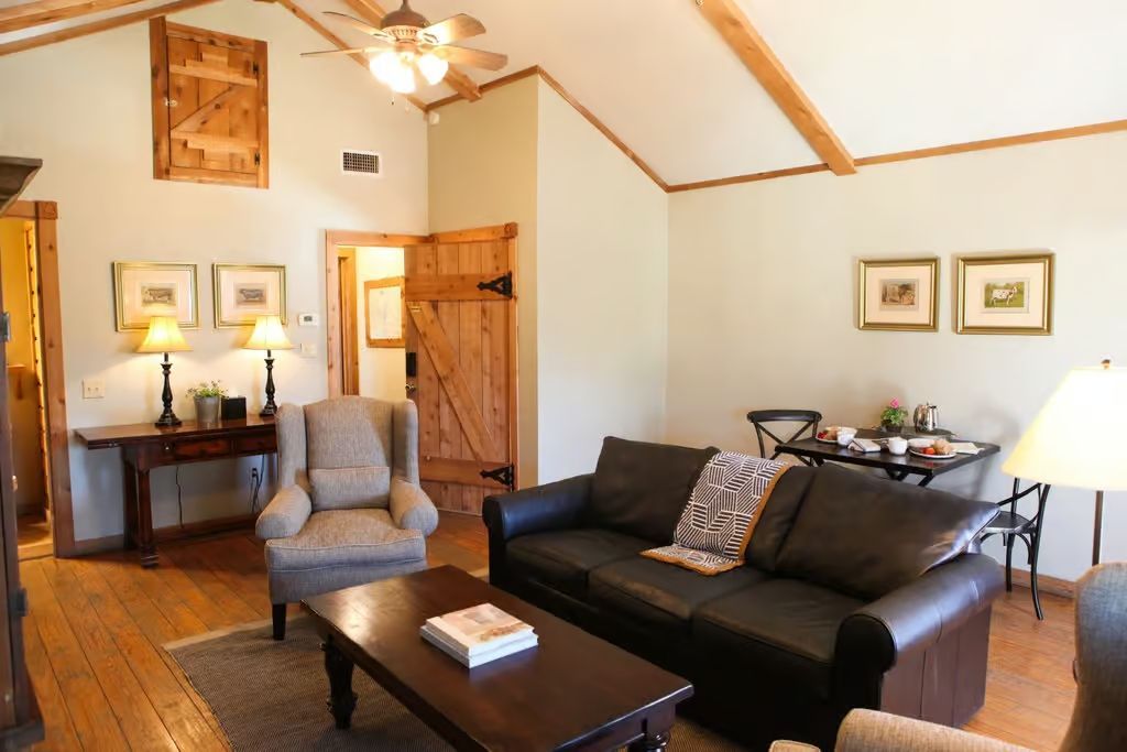 A living room with a couch a chair and a coffee table