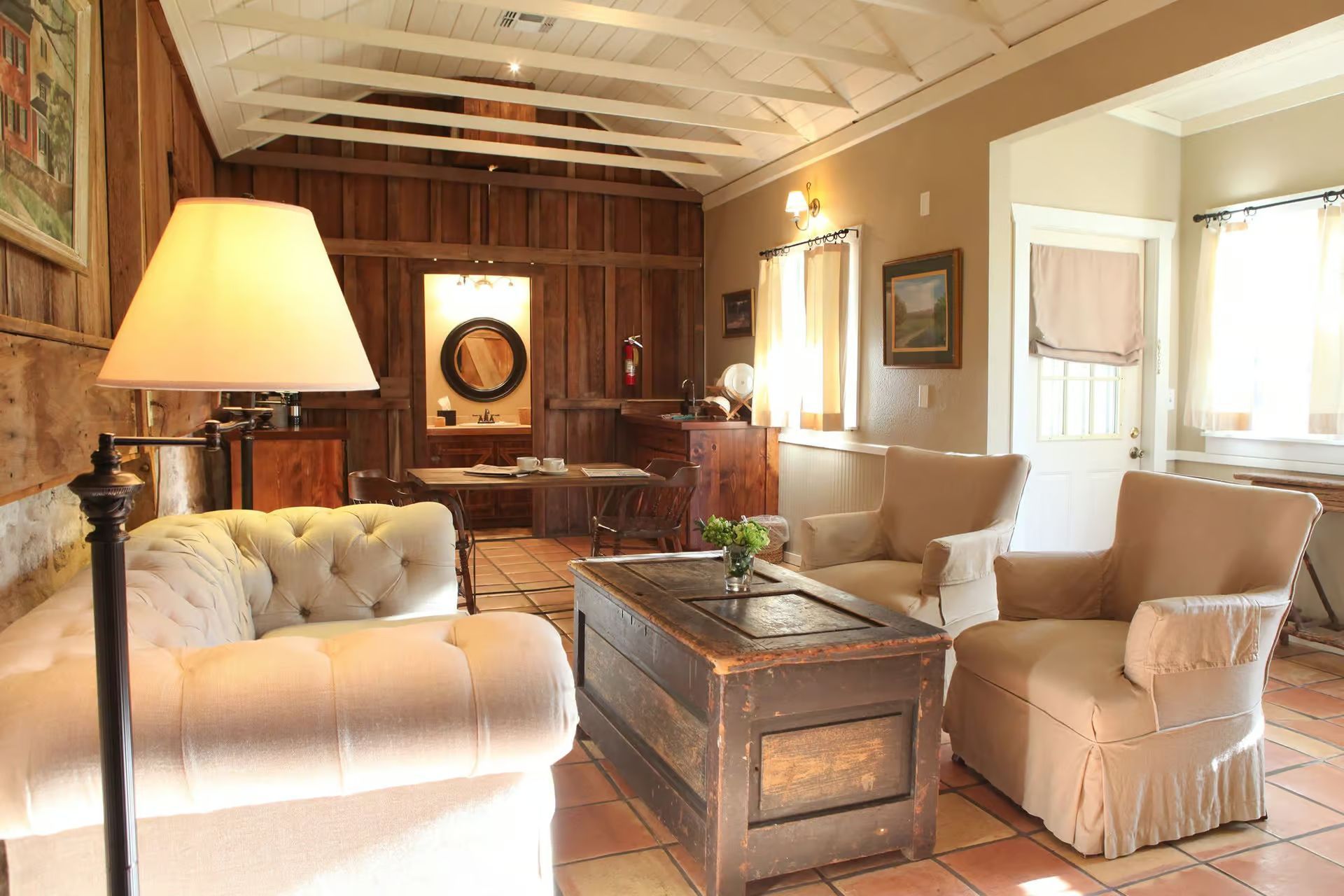 A bedroom with a large bed and a mirror