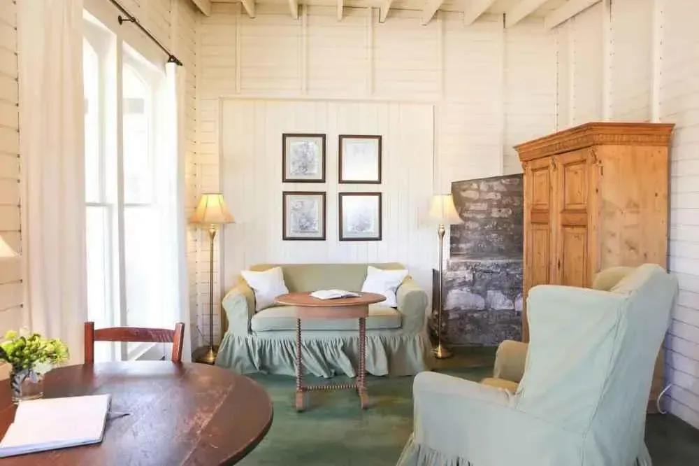A living room with a couch and chairs and a table