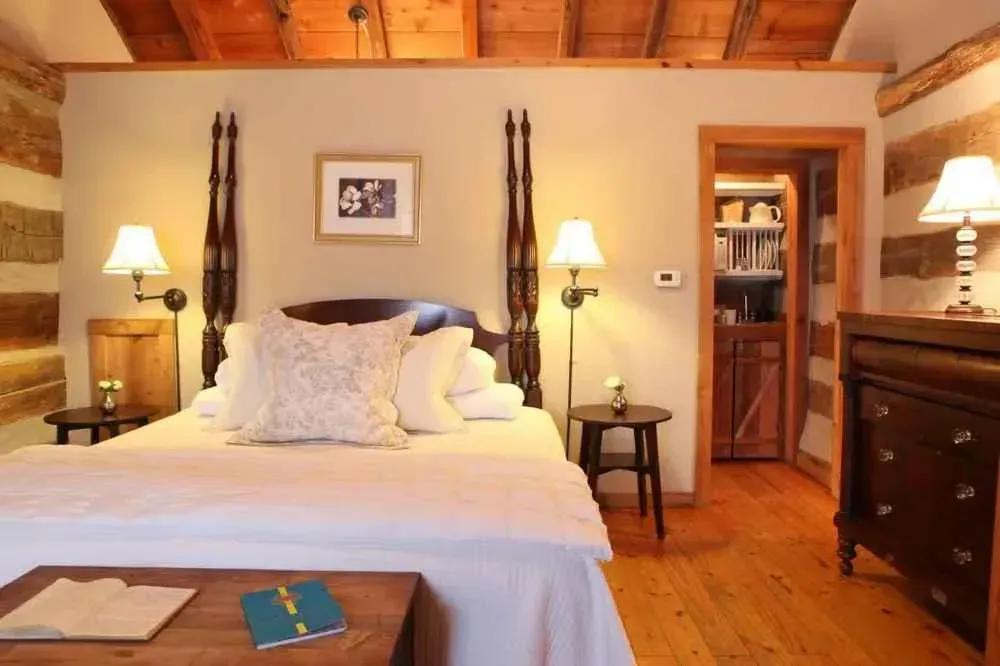 A bedroom in a log cabin with a king size bed