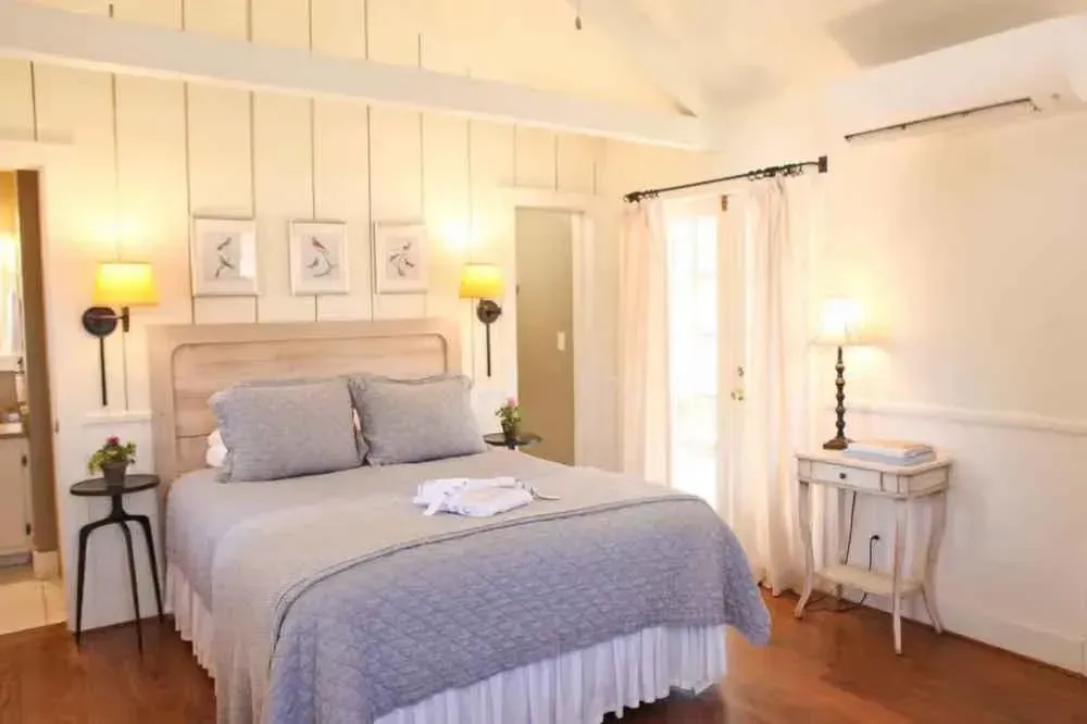 A bedroom with a king size bed and two nightstands