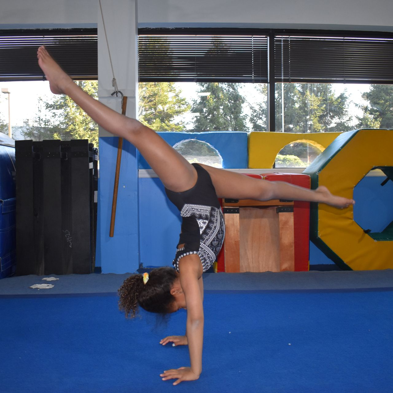 Young athlete practicing a split handstand during an Acro Tumbling class at Aerials Gymnastics in Eatontown, NJ