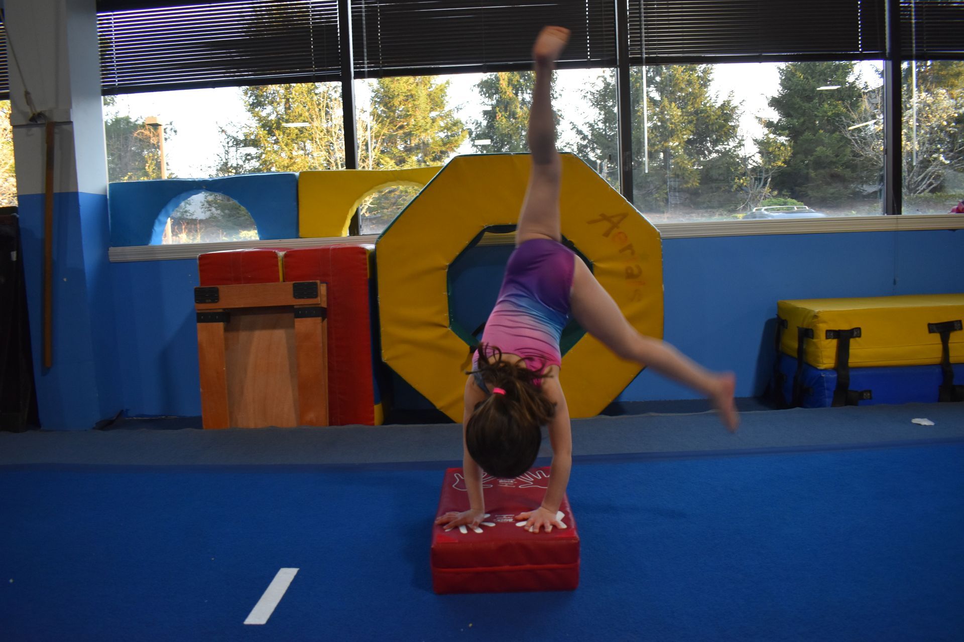 Young gymnast practicing a cartwheel during a tumbling class at Aerials Gymnastics in Eatontown, NJ