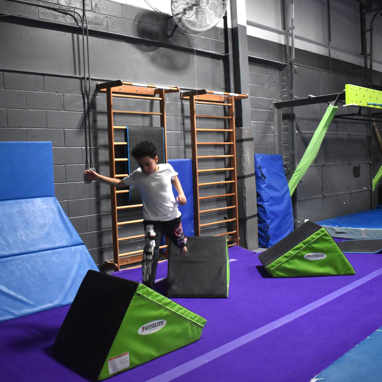 Child practicing obstacle-course skills during freestyle gymnastics at Aerials Gymnastics in Eatontown, NJ