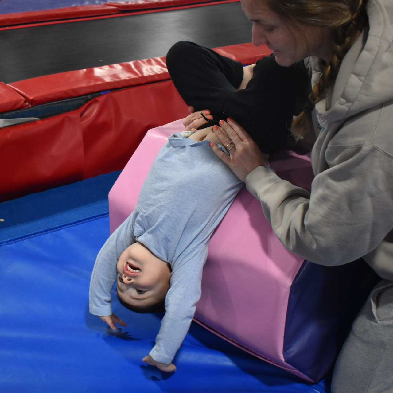 Parent helping a toddler practice a handstand during a Parent & Me gymnastics class at Aerials Gymnastics in Eatontown, NJ