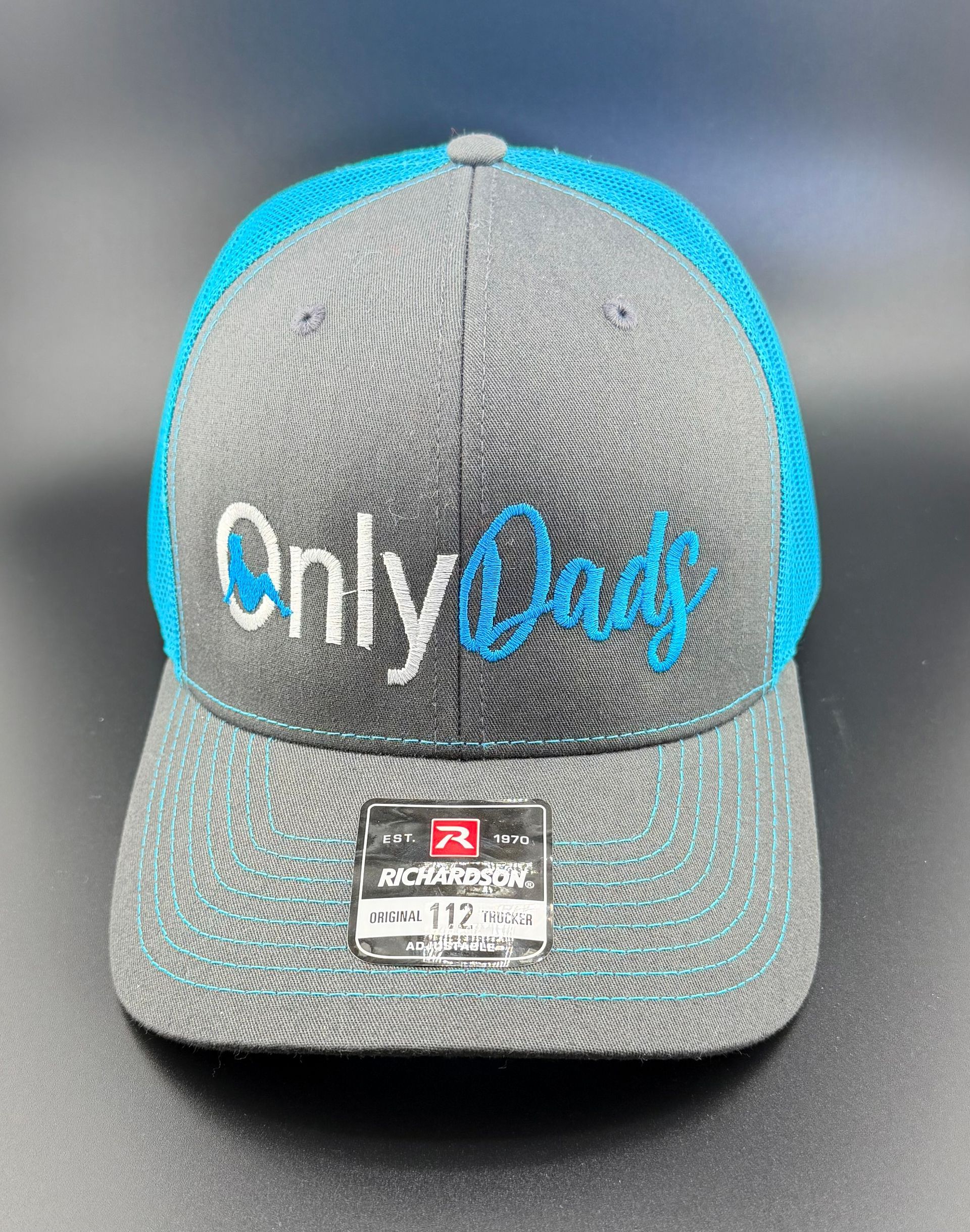 A gray trucker-style baseball cap with a blue mesh back and the embroidered text 