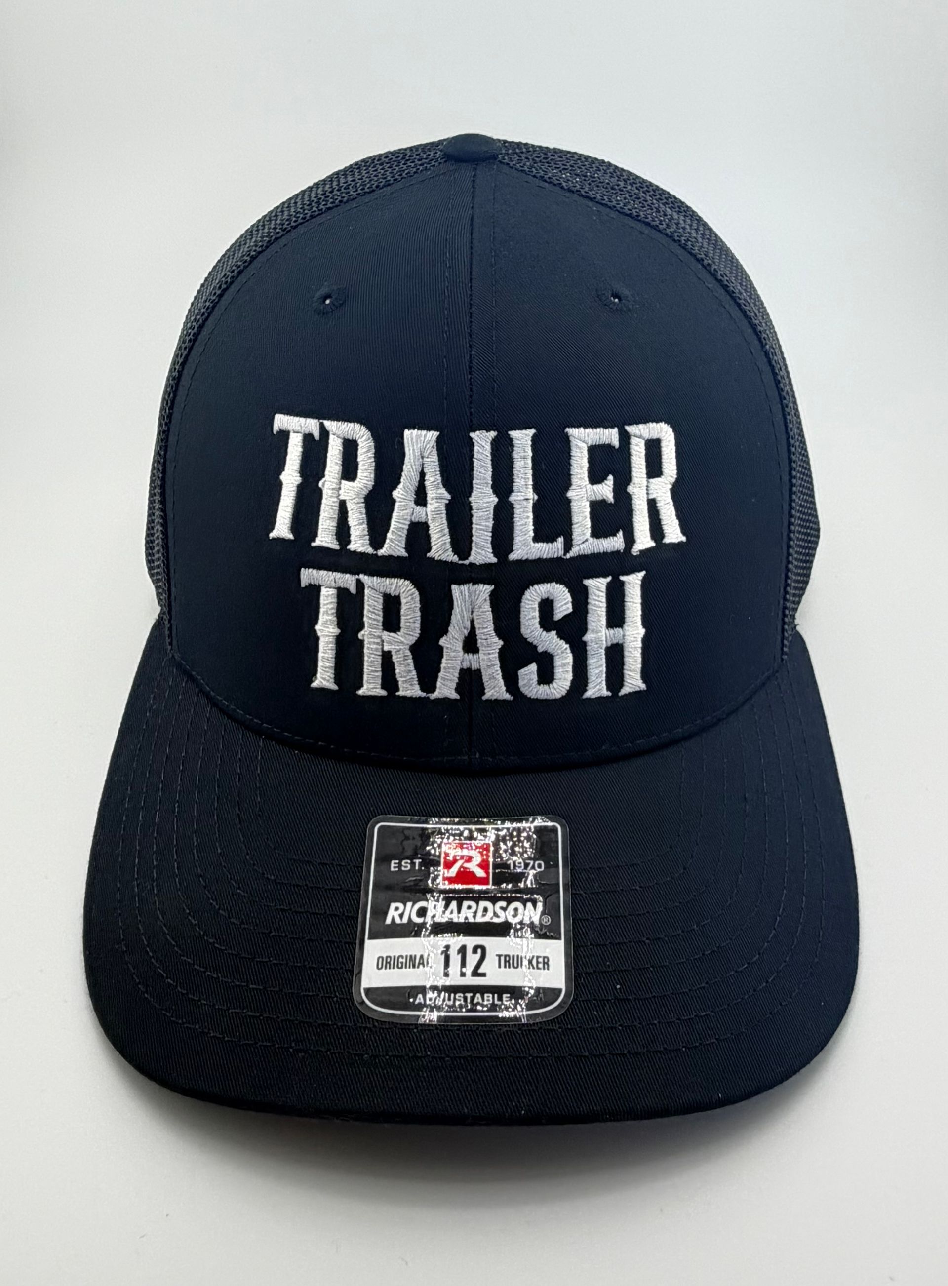 A navy blue trucker hat with a white 