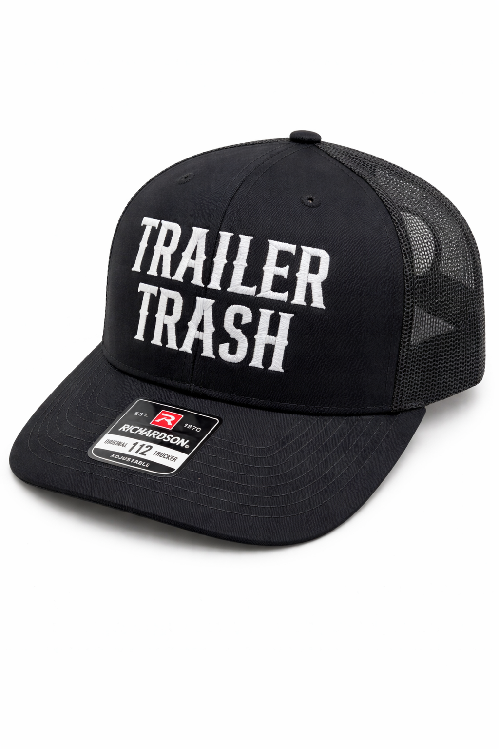A black mesh-back trucker hat with "TRAILER TRASH" embroidered in white text on the front and a small sticker on the brim.