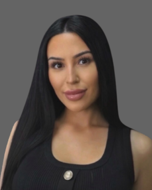 Portrait of a woman with long dark hair wearing a black top against a gray background