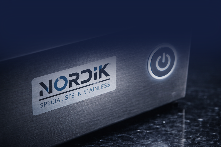 Close-up of a black NORDIK stainless steel glass washer with a glowing power button.