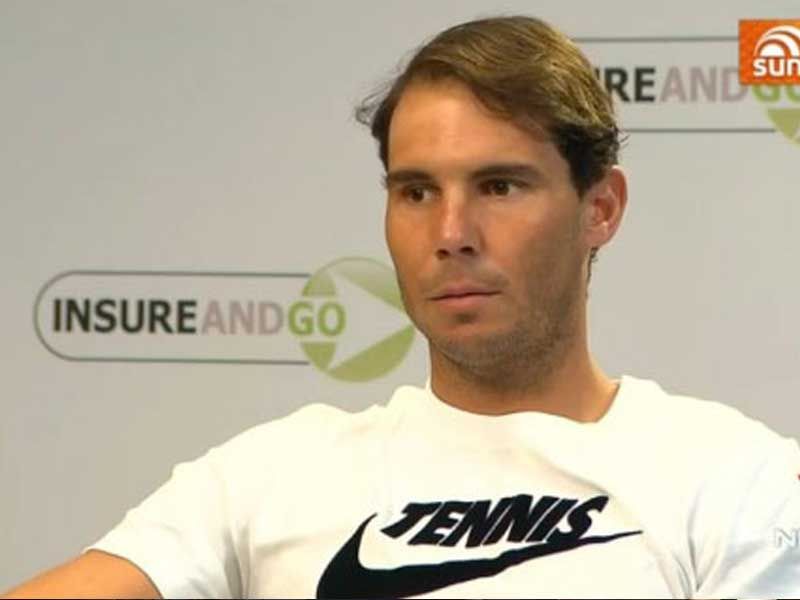 Rafael Nadal sits in front of an 