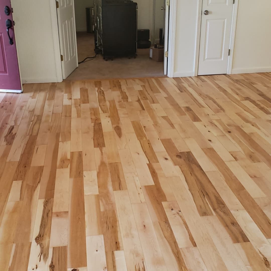 Freshly finished hardwood floor in a hallway and room interior