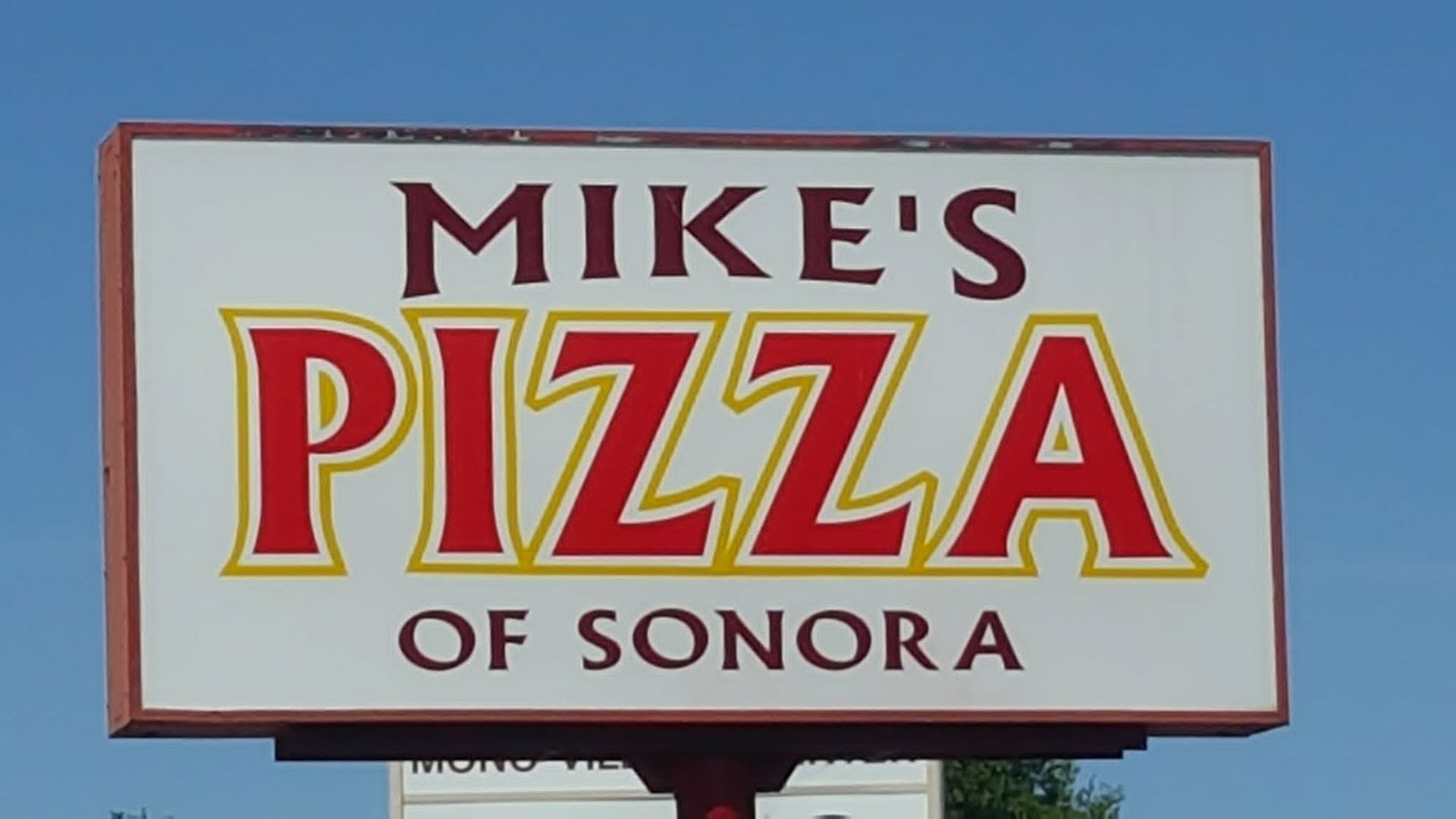 Mike’s Pizza of Sonora sign in red and yellow on a white background