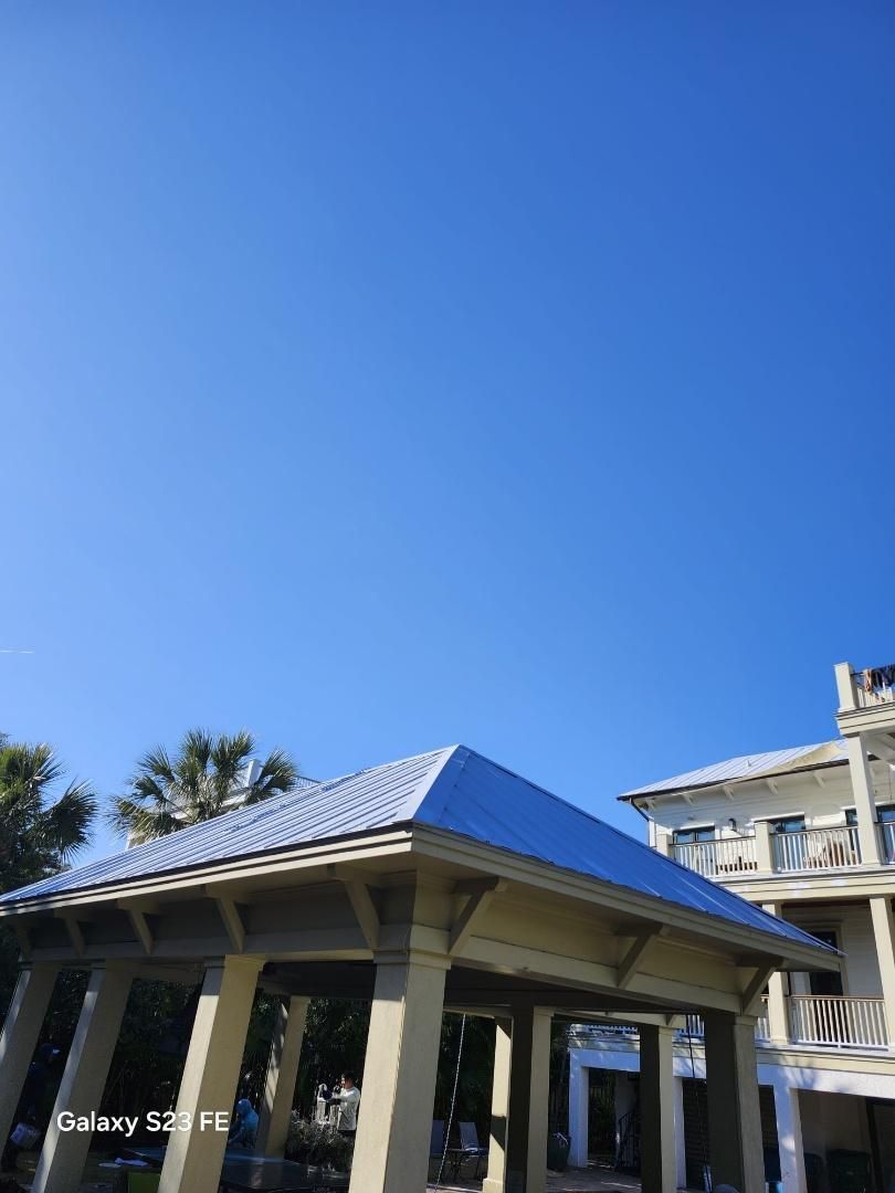 Gazebo and building against a clear blue sky.