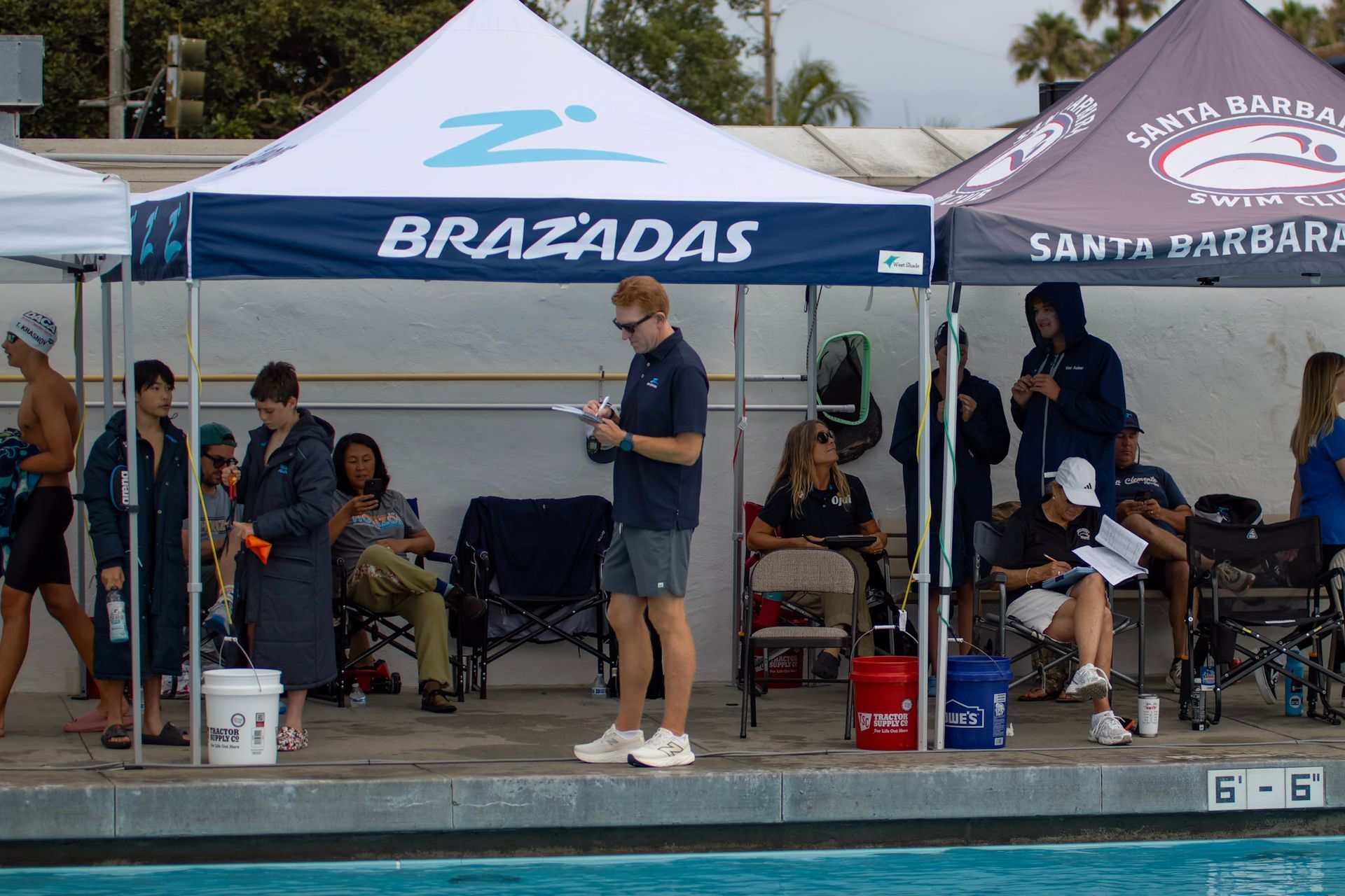 B-Town Brazadas Swim Club Masters swimmers at the starting blocks in the pool at East Side Aquatics Center in Bakersfield, CA