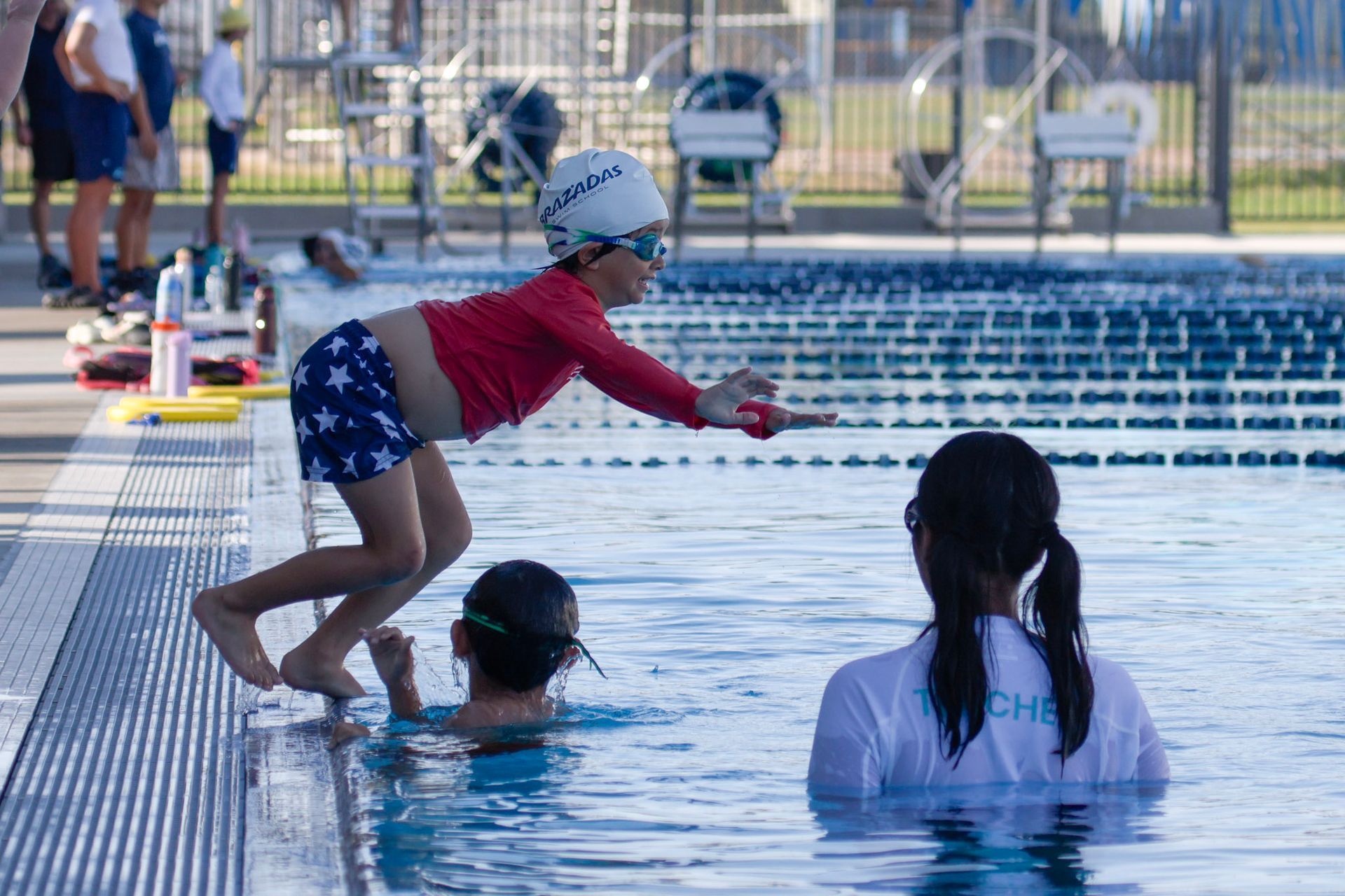 B-Town Brazadas Swim Club athletes participating in swim school in the pool at East Side Aquatics Center in Bakersfield, CA