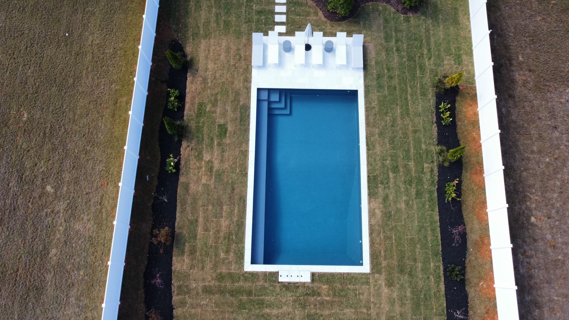 Backyard pool with pipeless filtration system and clean design
