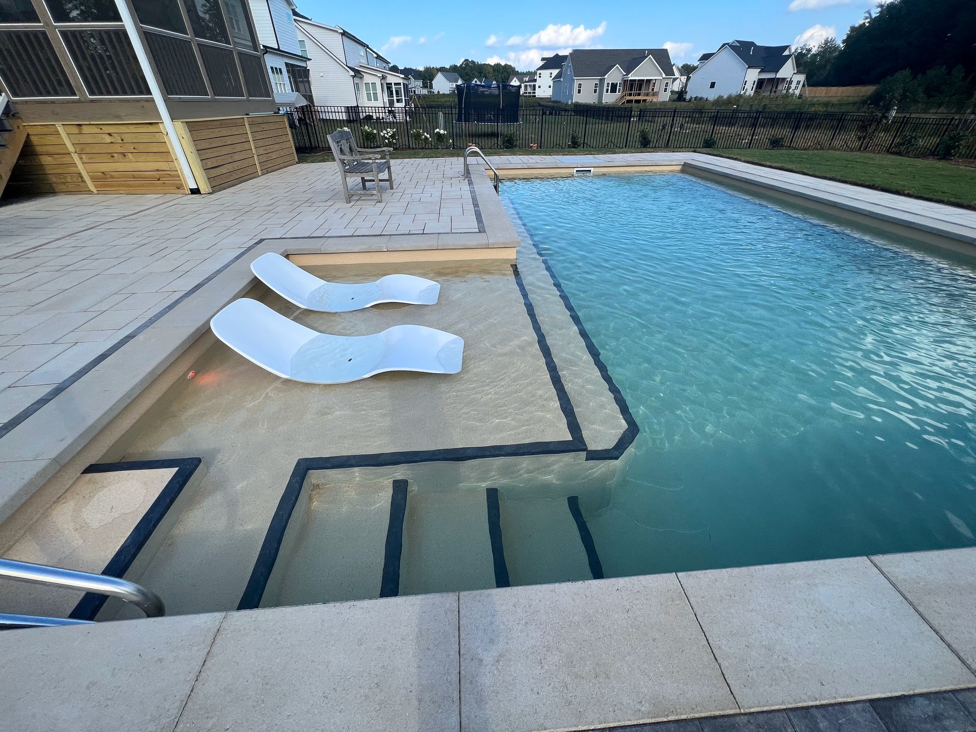 Pool with integrated bench seating and ambient lighting