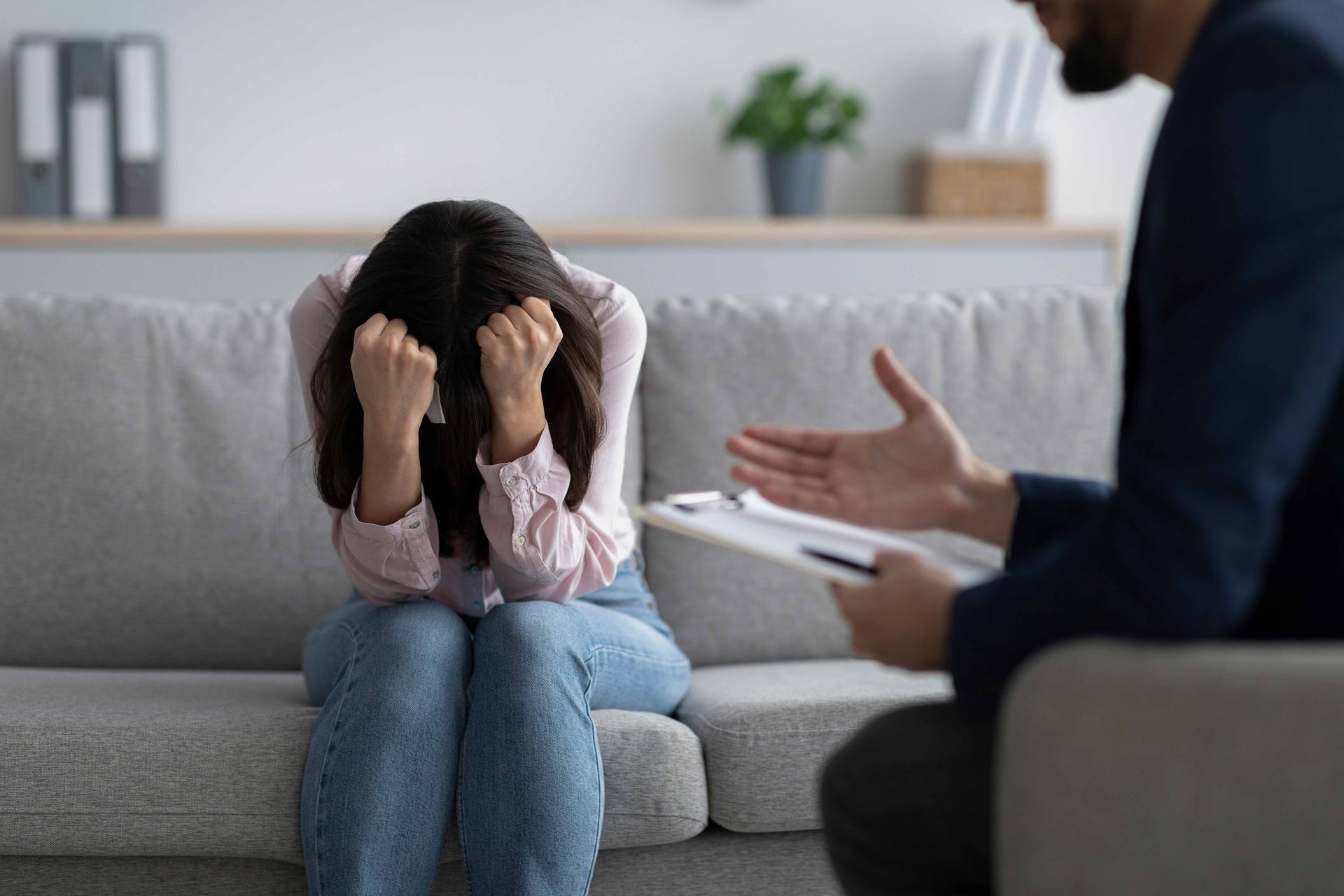 Stressed woman having session at psychologist's office.